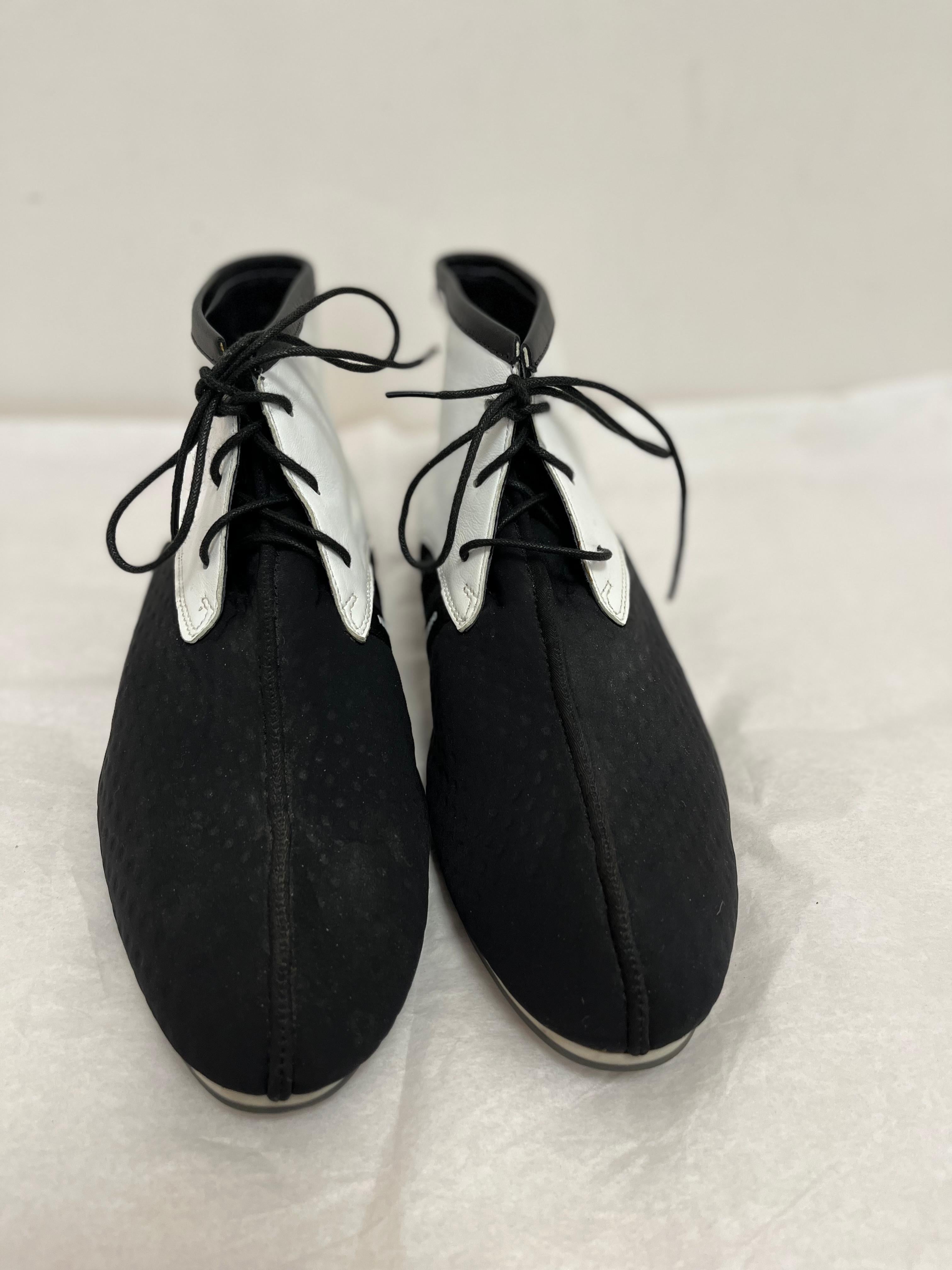 These Yohji Yamamoto leather and neoprene booties are hard to find, and where a collaboration with Adidas. The white top part is leather, and rest black neoprene.

These are lace up booties, and not sneakers. The little heel is black with white