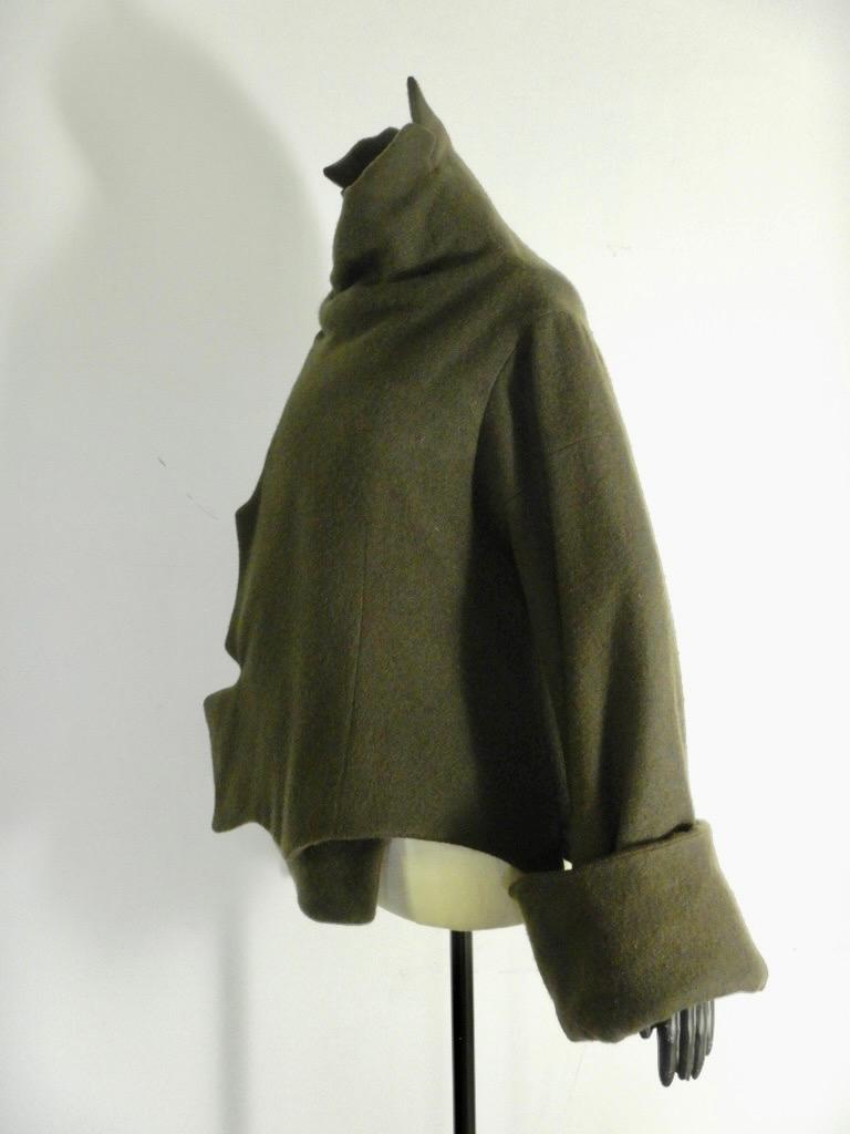 Fabulous vintage Yohji Yamamoto wool (70%) and cashmere (30%) coat in a green-brown color with snap closures.

Tagged a size 2 (Japan).

The coat is in good pre-owned condition. While there are no stains or holes, there are two spots of moth damage