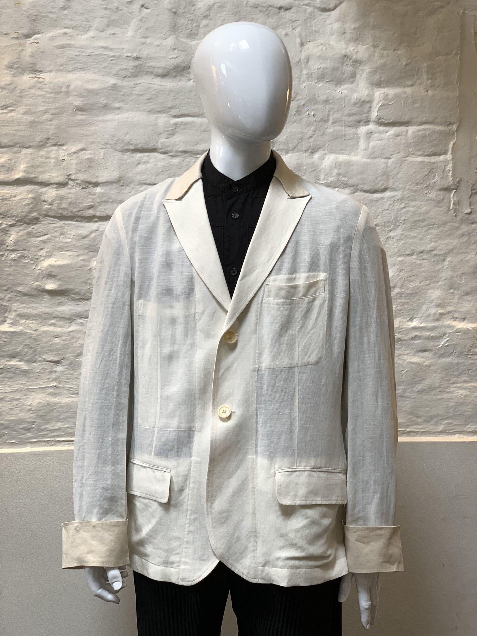 Yohji Yamamoto White Linen Jacket made in Japan from linen. 

Yohji Yamamoto is known for the avant-garde spirit of his clothing. His signature oversized silhouettes in black often feature drapery in varying textures. Since the establishment of Y's