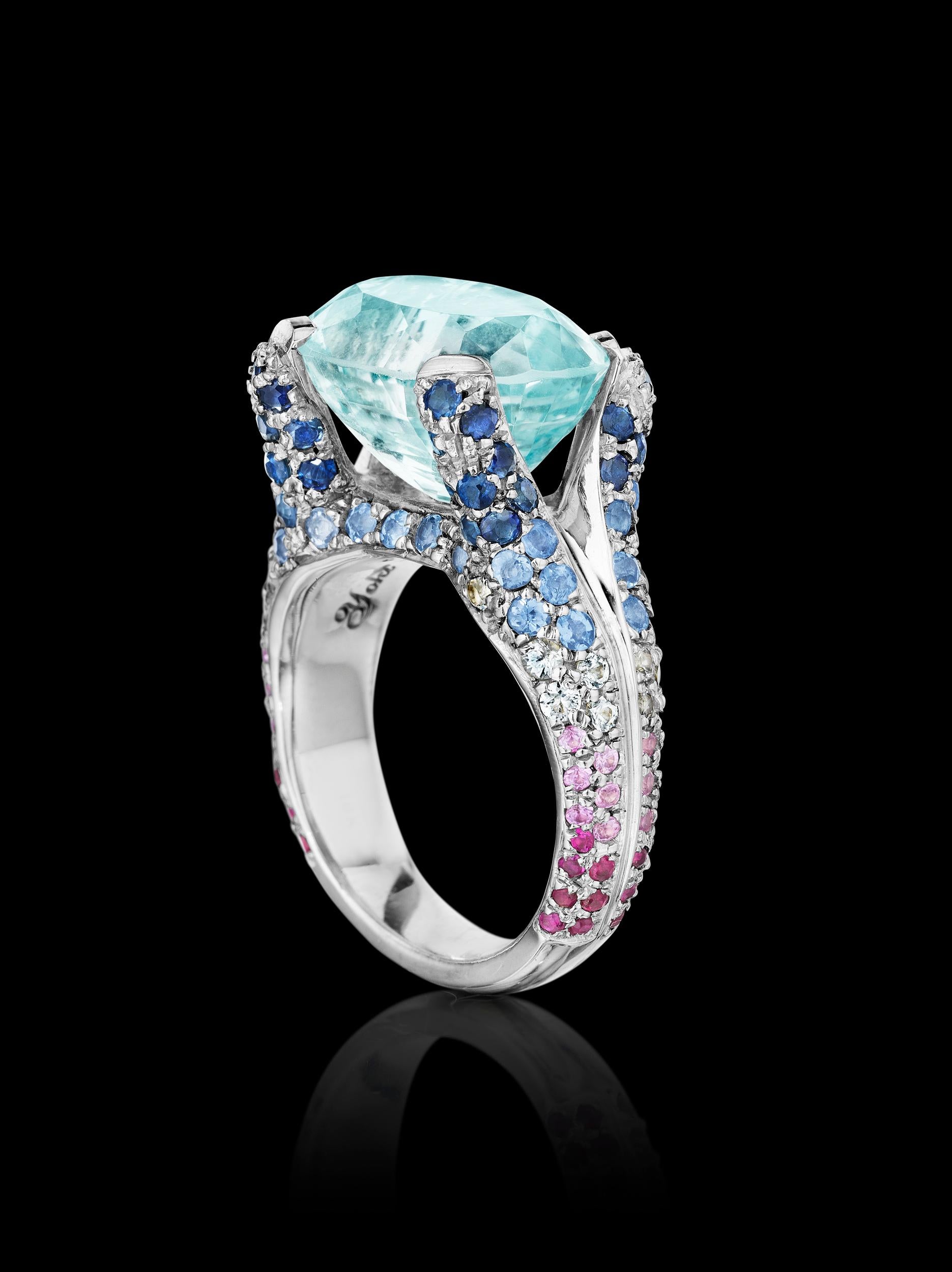 Ring features Aquamarine, Rubies, Deep Blue Sapphires, Light Blue Sapphires, White Sapphires and Rubies. Inspired by the lush tropical forests alongside of the Caribbean Coastline.  Ring is set in 18k white gold. 

Size 7.25 

Center stone:
