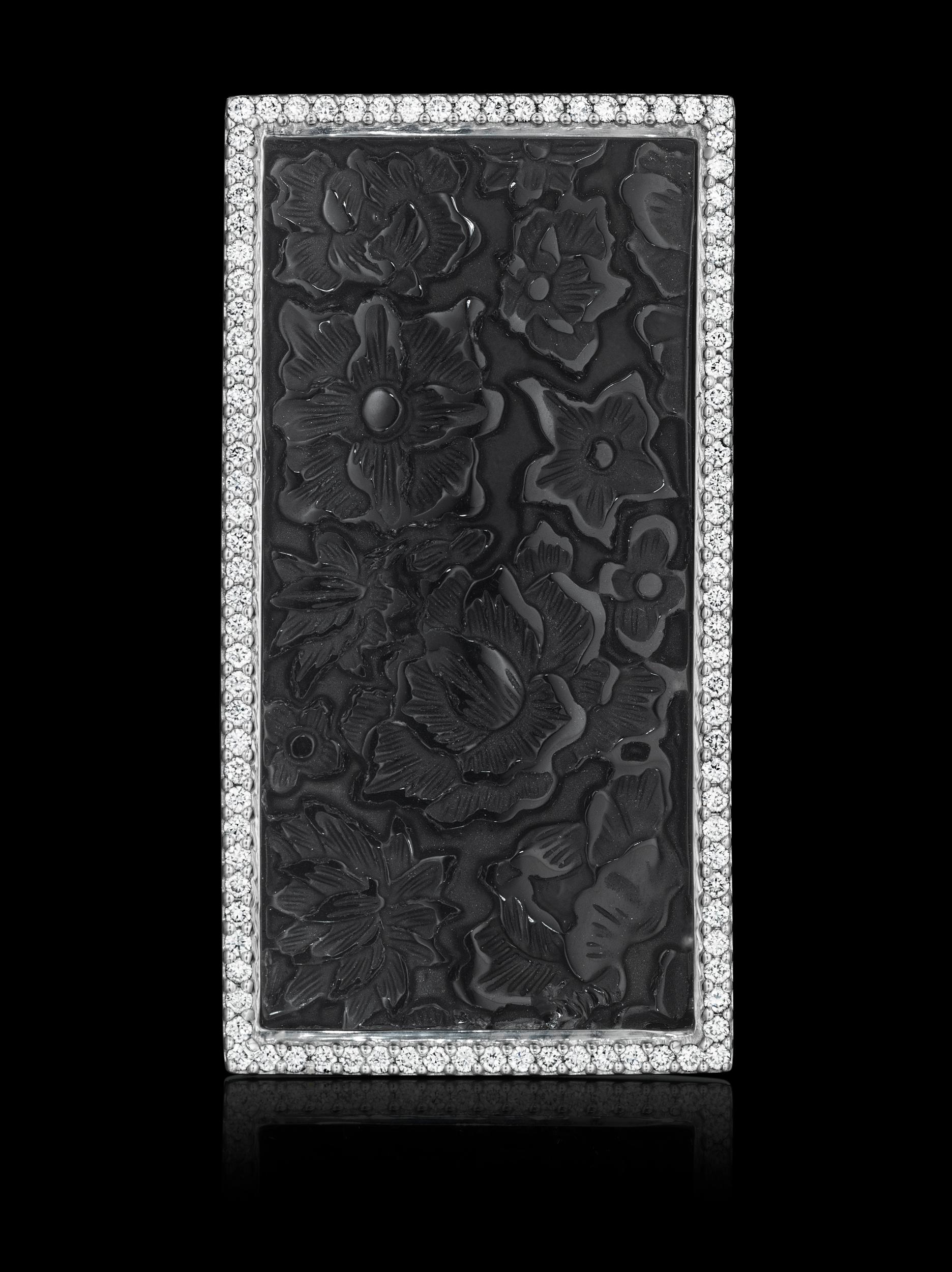 One-of-a-kind Convertible Brooach-Pendant YOKI Design. Piece features Carved Black Onyx and Diamonds set in 18k white gold. 

Centerstone: Carved Onyx, 52.84x26.55mm, 65.7cts. (approx.)

Side Stones: 90 Round diamonds, 1.7cts. (approx.)   

Piece