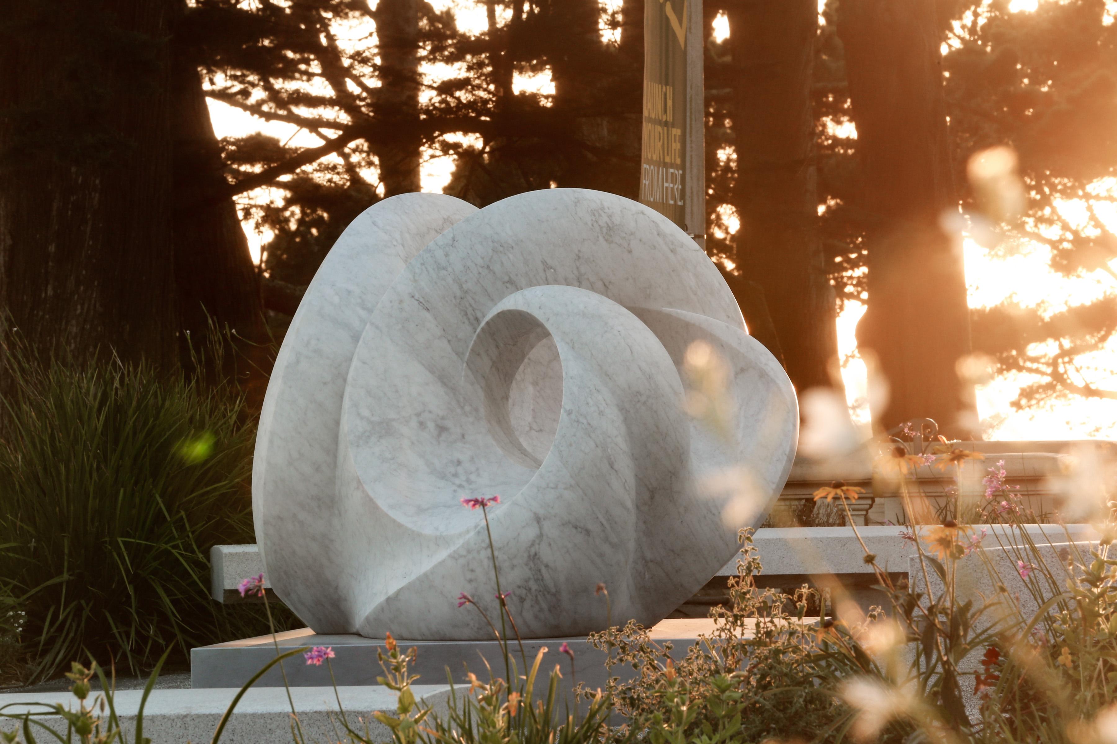 Tides by Yoko Kubrick is an abstract marble sculpture carved in Carrara marble from the Apuan Alps of Italy. The work explores the themes of time and water movement, symbolized by the German term 'der Gezeiten' which refers to the ebb and flow of