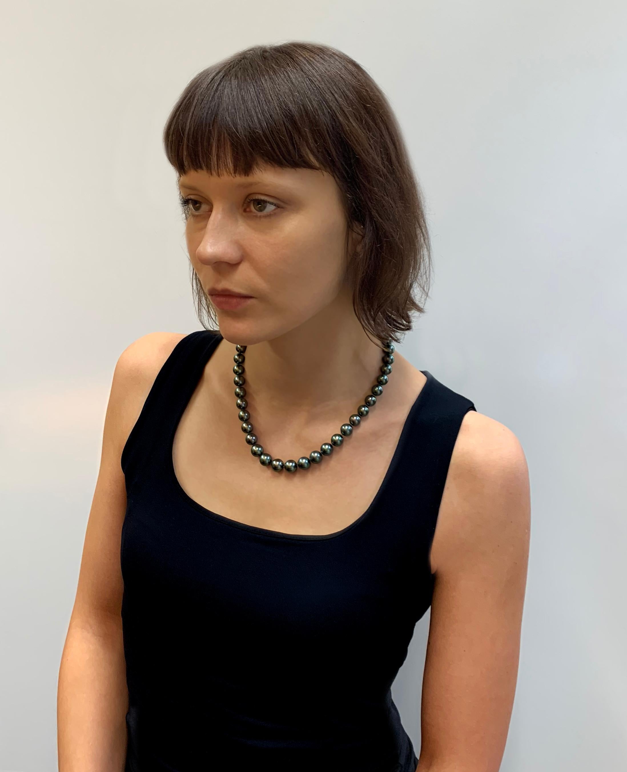 The metallic lustre of these Fine Quality Grey Tahitian Pearls are showcased spectacularly in this classic row necklace by Yoko London. The Pearls in the necklace gently graduate in size, and have each been hand selected by our experts for their