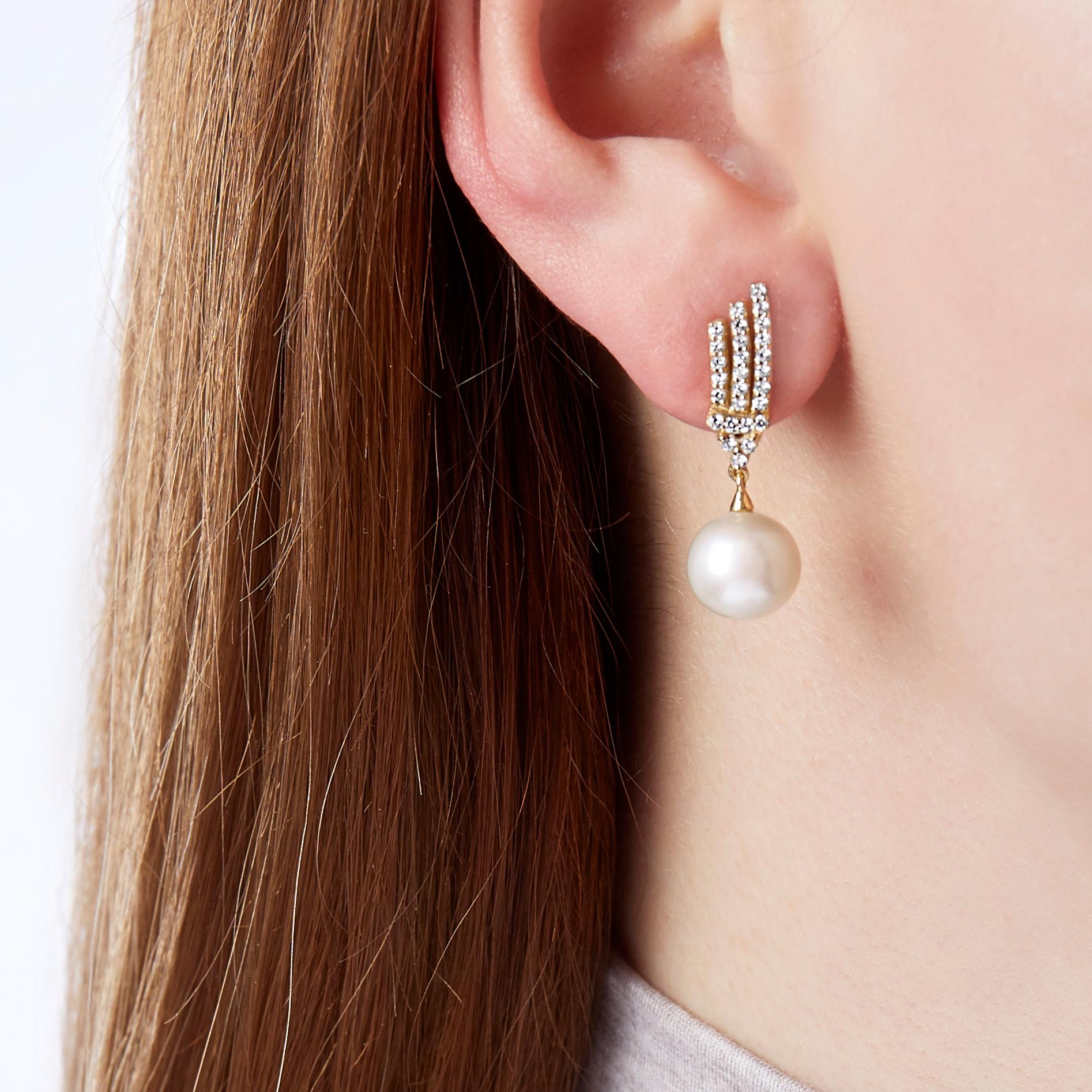 These elegant earrings by Yoko London feature luminous Freshwater pearls beneath an intricate diamond design. Set in 18 Karat yellow gold, these earrings are reminisicent of the Art Deco earring and have been expertly handcrafted in our London