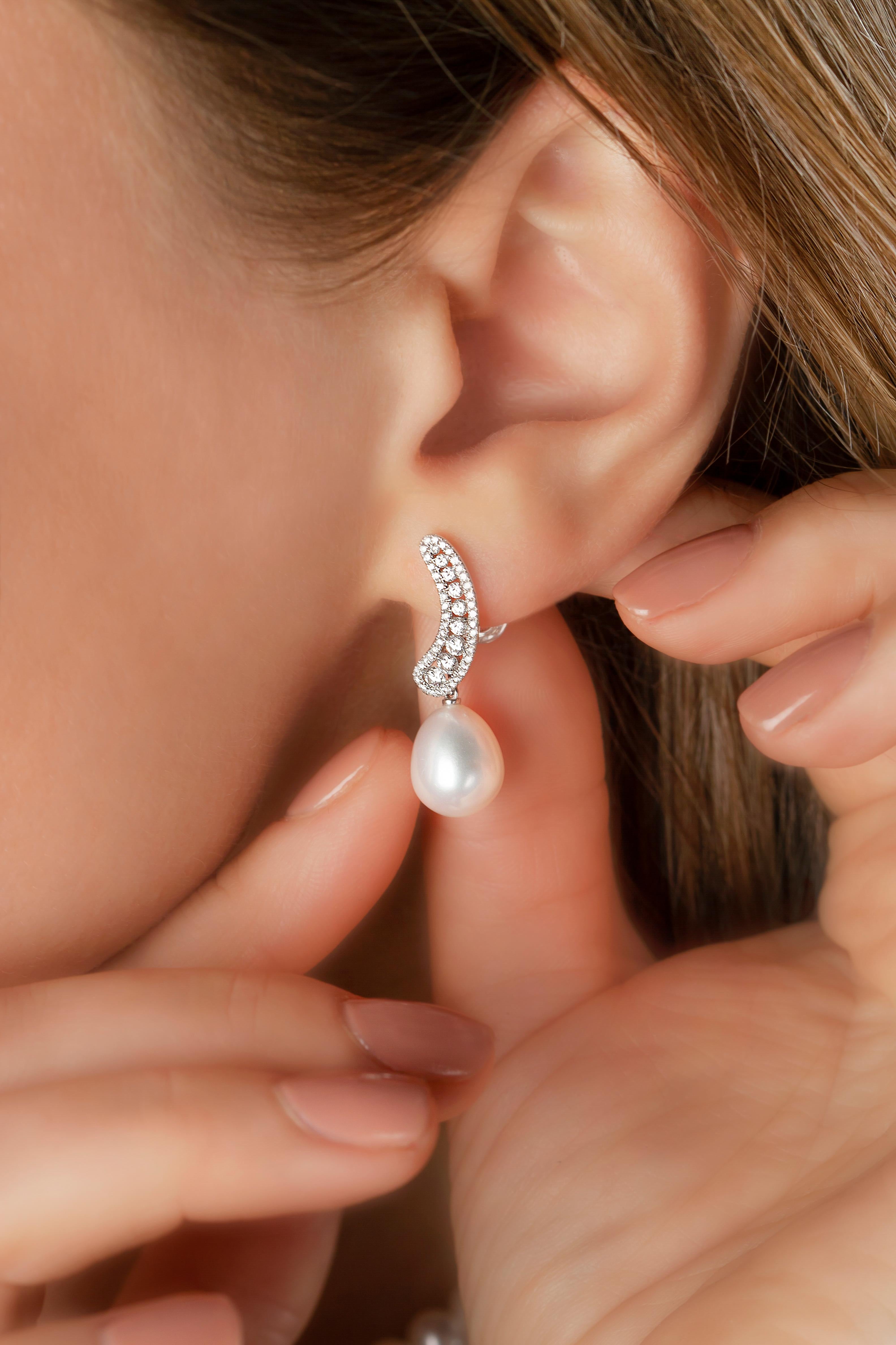 These scintillating earrings by Yoko London feature lustrous drop-shaped pearls beneath a smooth curve of diamonds. These spectacular earrings will add the perfect finishing touch to any outfit and would particularly suit a beaming bride on her