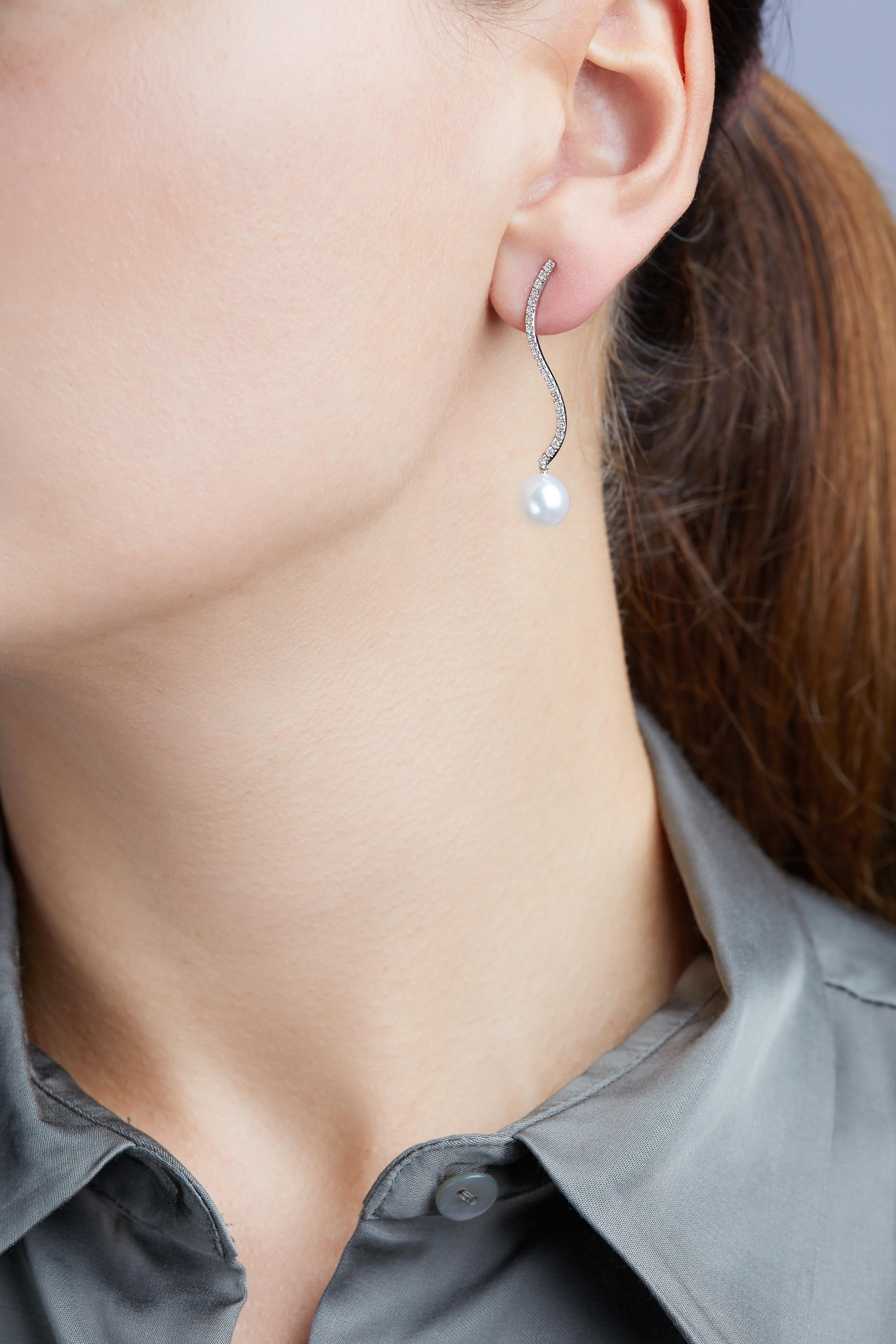 These elegant earrings by Yoko London feature lustrous Freshwater pearls beneath delicate diamond curves. Timeless and sophisticated, these earrings will add a touch of glamour to any outfit.

- 8.5-9mm Freshwater Pearl 
- 18k White Gold 
- 0.39cts