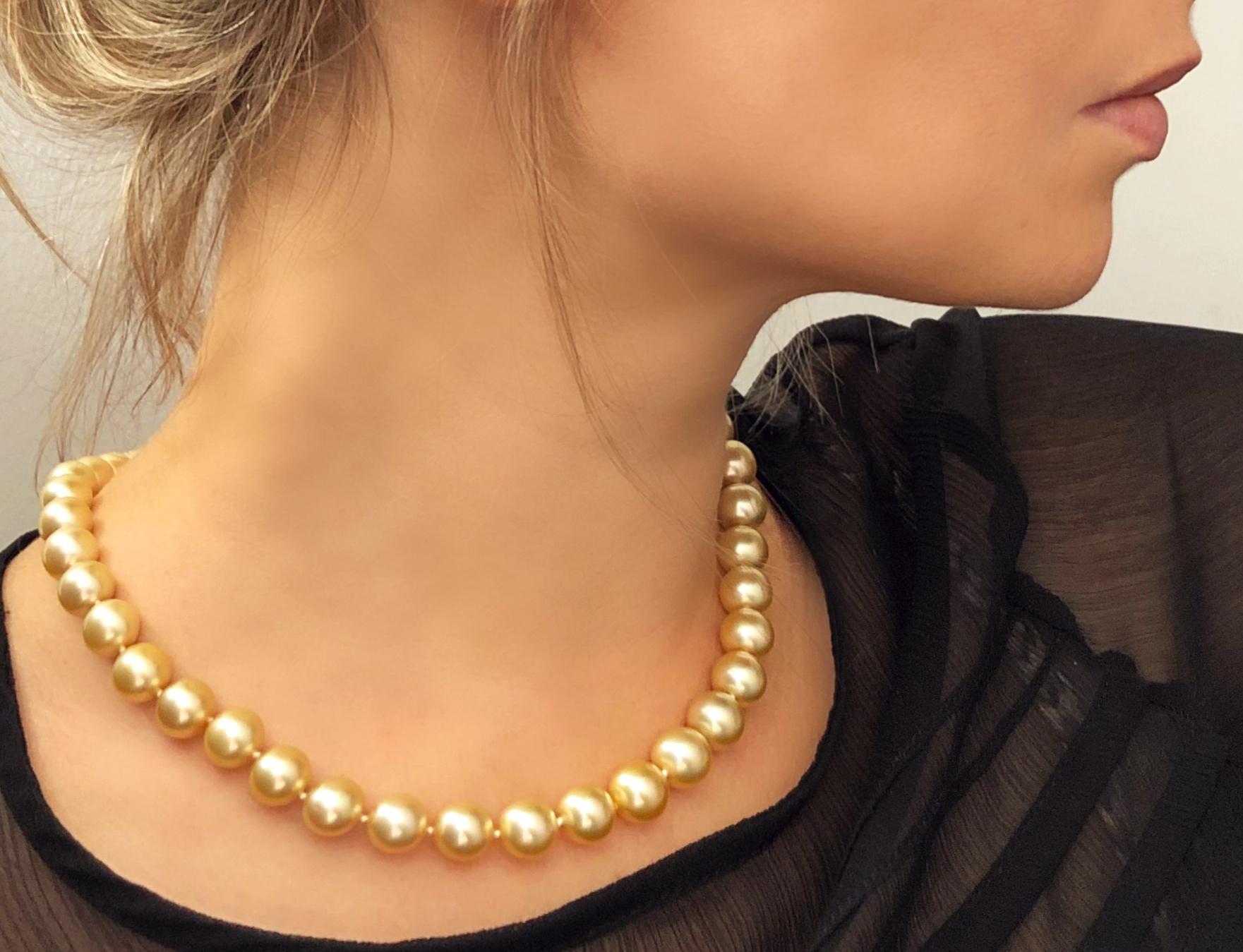 A beautiful classic row necklace of high-quality Indonesian Golden South Sea pearls strung onto silk and secured to an 18 Karat Yellow Gold diamond-set ball clasp. The intrinsic luxury of Golden South Sea pearls is apparent from the rich colour and