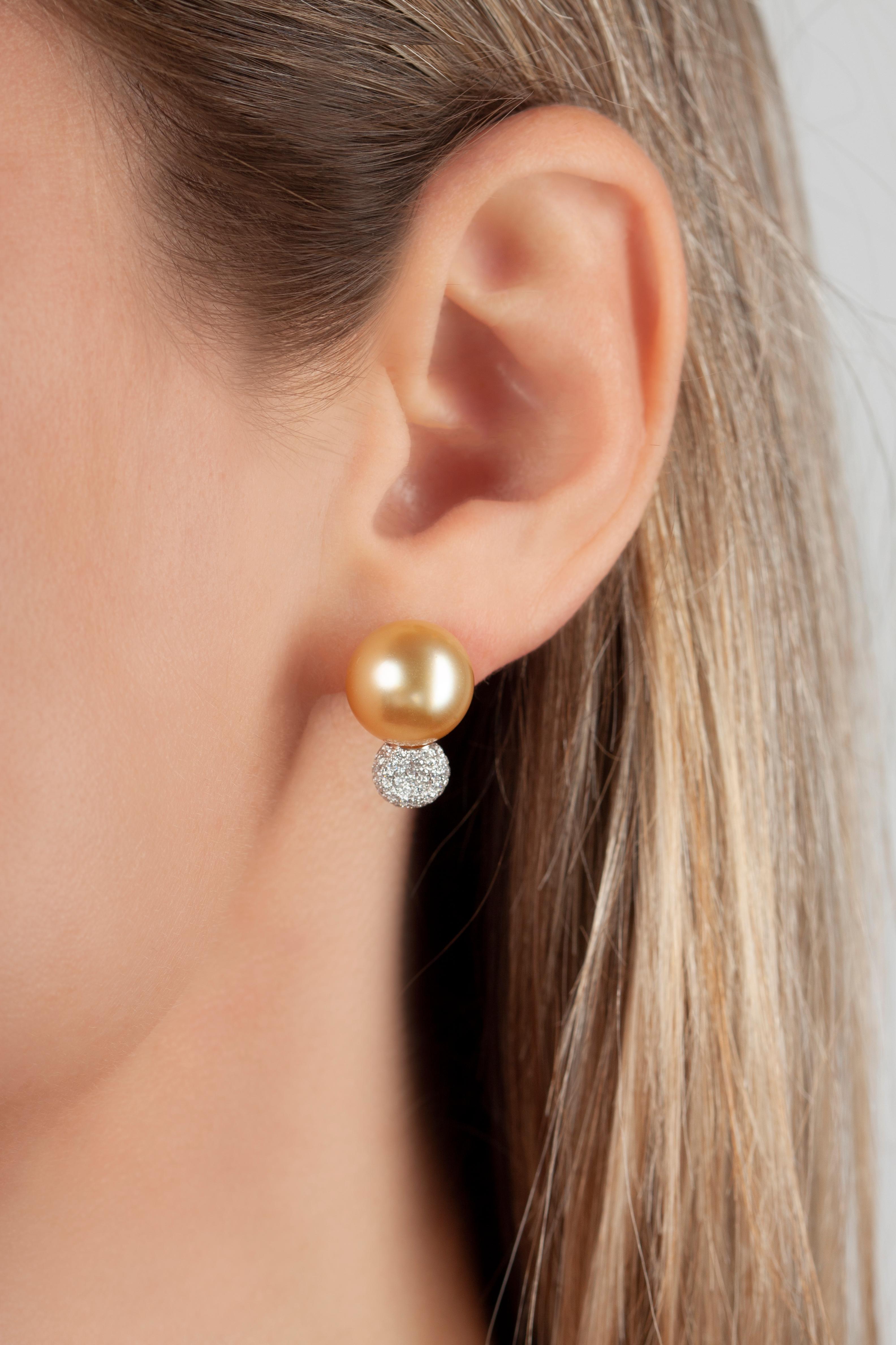 These spectacular earrings by Yoko London feature vivid Golden South Sea pearls sat atop a scintillating cluster of diamonds. The rarest of all pearl varieties, the Golden South Sea pearls featured in these earrings have been matched and