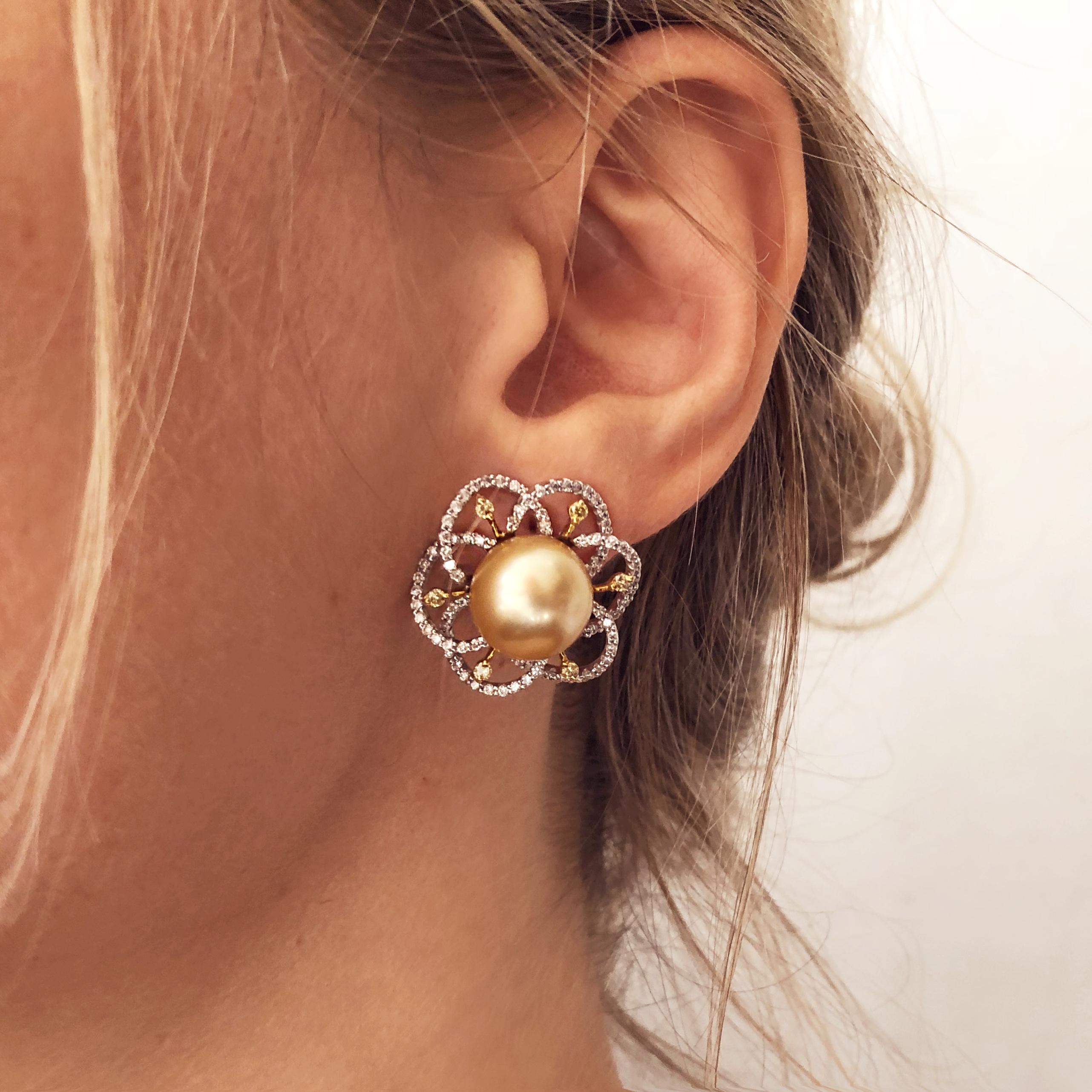These unique flower shaped earrings by YOKO London feature 12-13mm Golden South Sea pearls at the heart of their design. The rich colour of these pearls is complimented perfectly by the delicate 18 Karat white gold floral design which completed by a