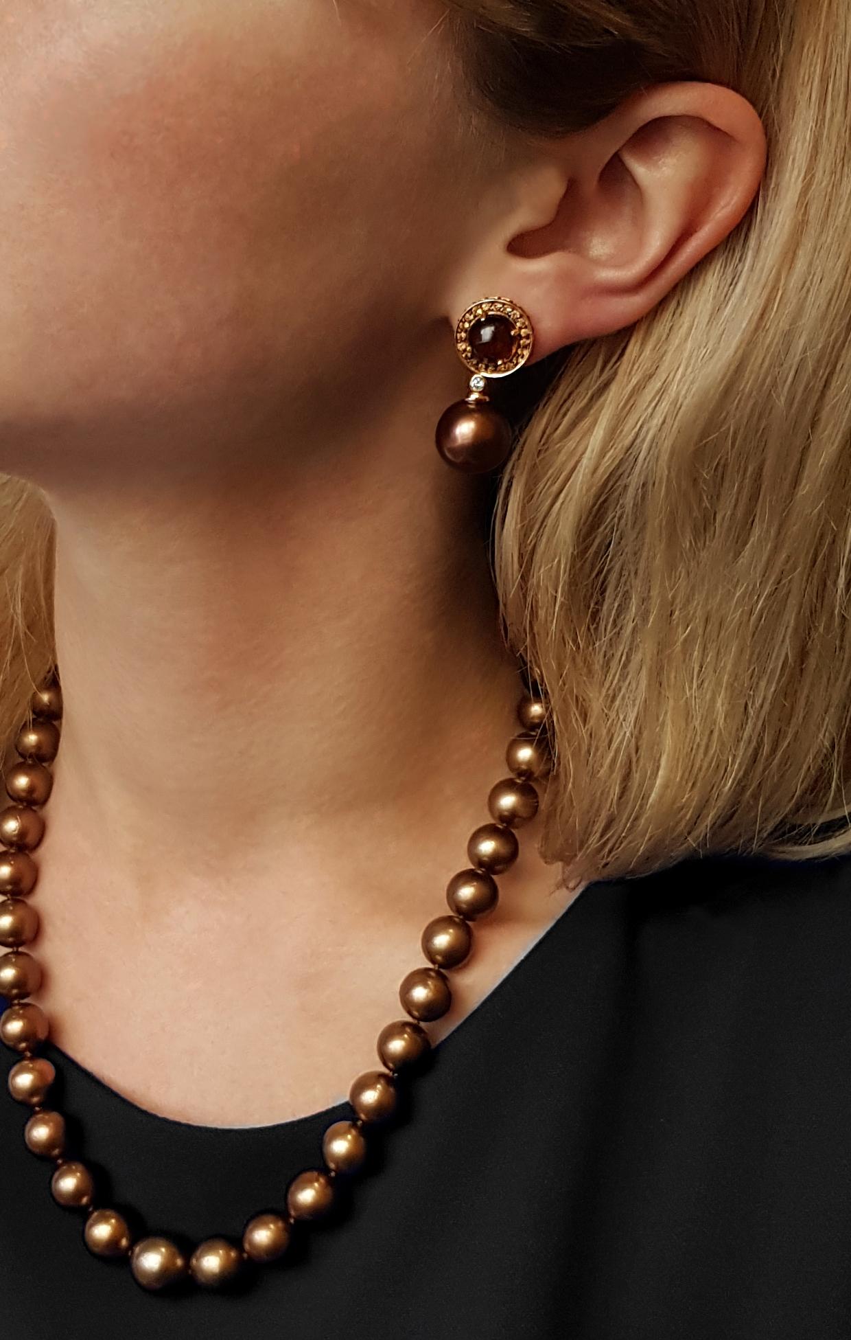 These unusual earrings from Yoko London feature a sumptuous combination of chocolate-coloured Tahitian pearls, cognac quartz and yellow sapphires. To enrich these rich hues further, the earrings are set in 18 Karat yellow gold, allowing the colours