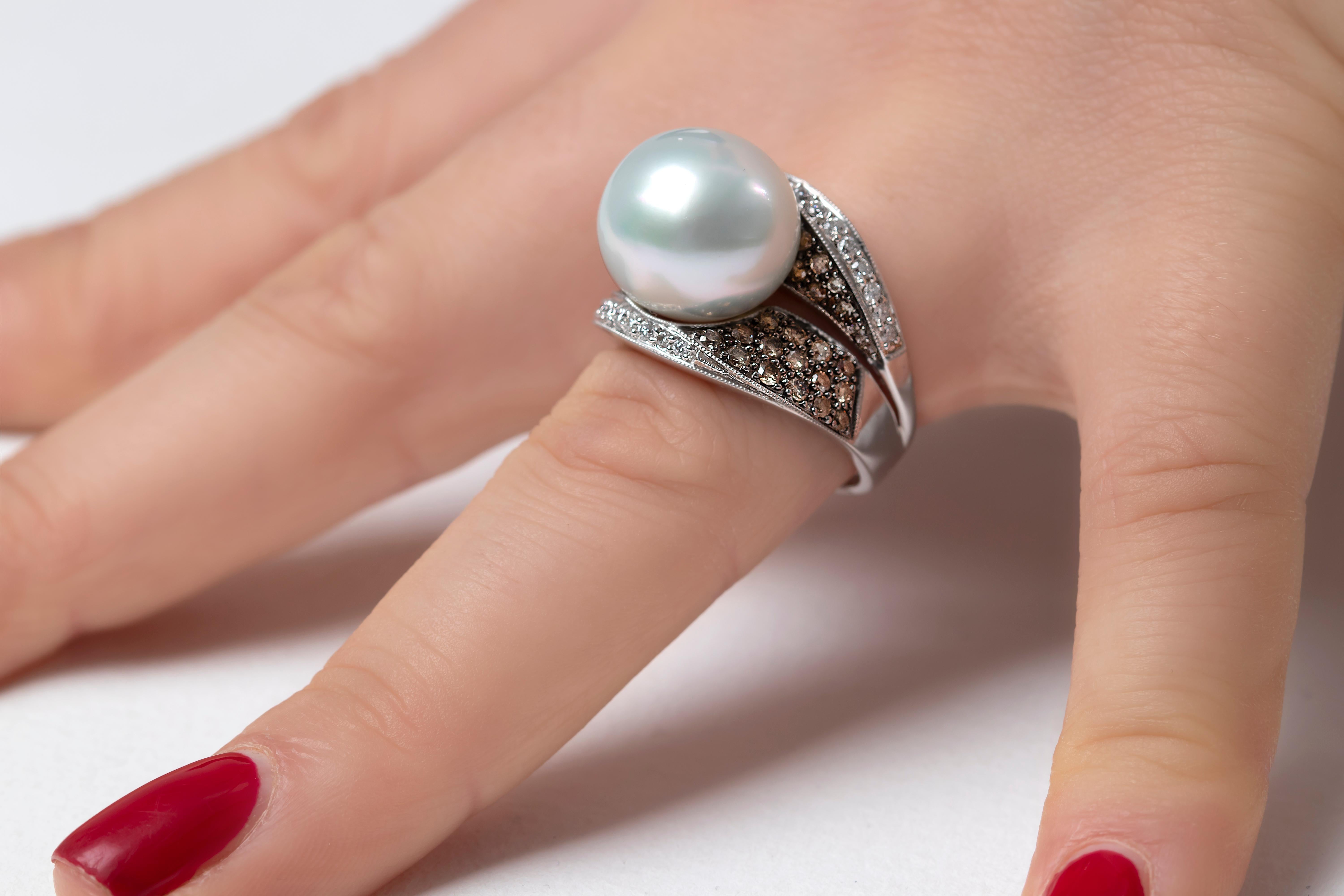 This elegant ring by Yoko London features a lustrous South Sea Pearl, set amongst a scintillating sweep of brown and white diamonds. Bold and striking, this one of a kind ring will add a touch of unique elegance to any formal look. 
-	13-14mm South