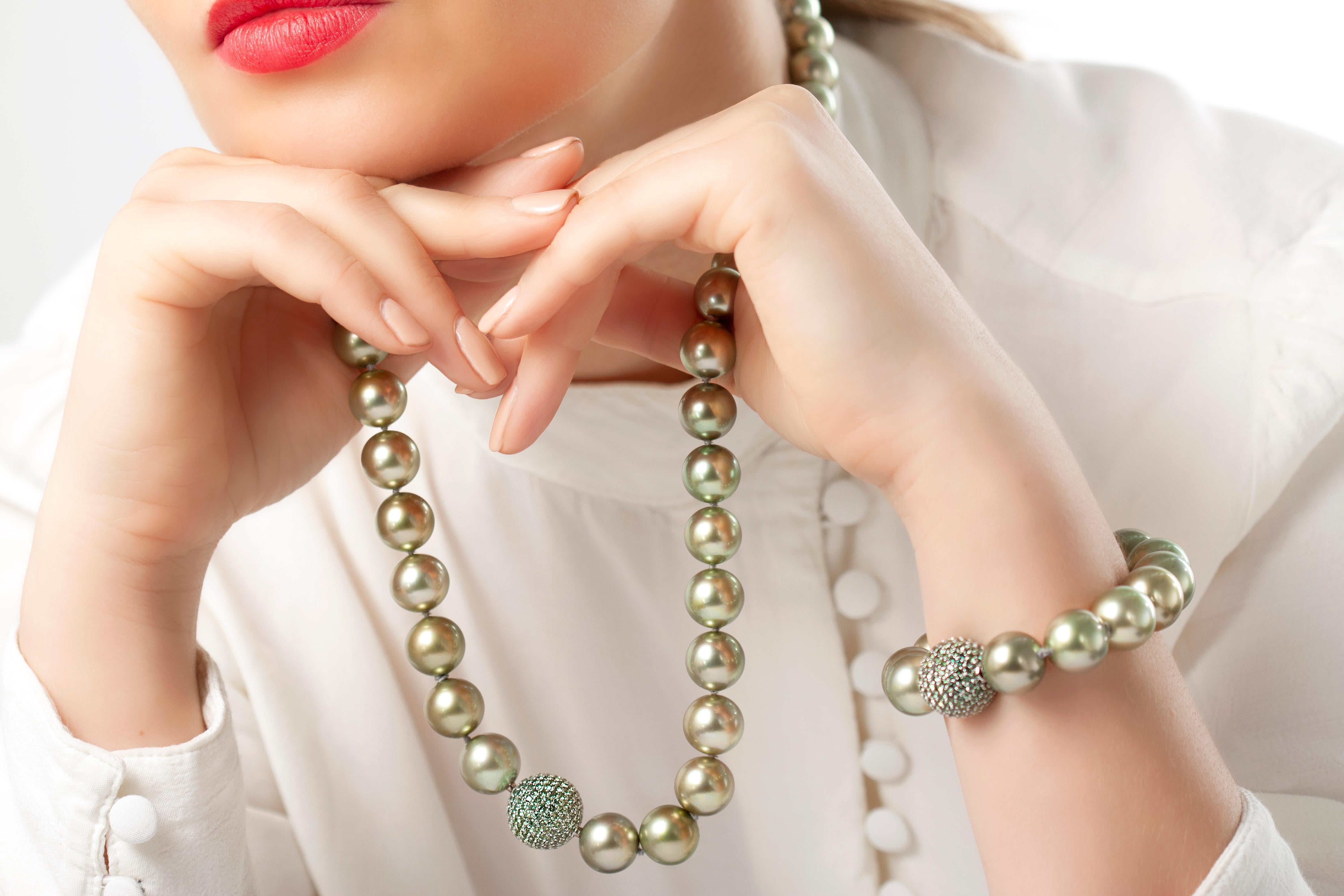 This spectacular necklace by Yoko London features large, pistachio-colour Tahitian pearls, which softly graduate in size from 12-14.9mm, allowing the necklace to sit elegantly upon its wearer’s neck. The soft hue of the pearls is enriched by the