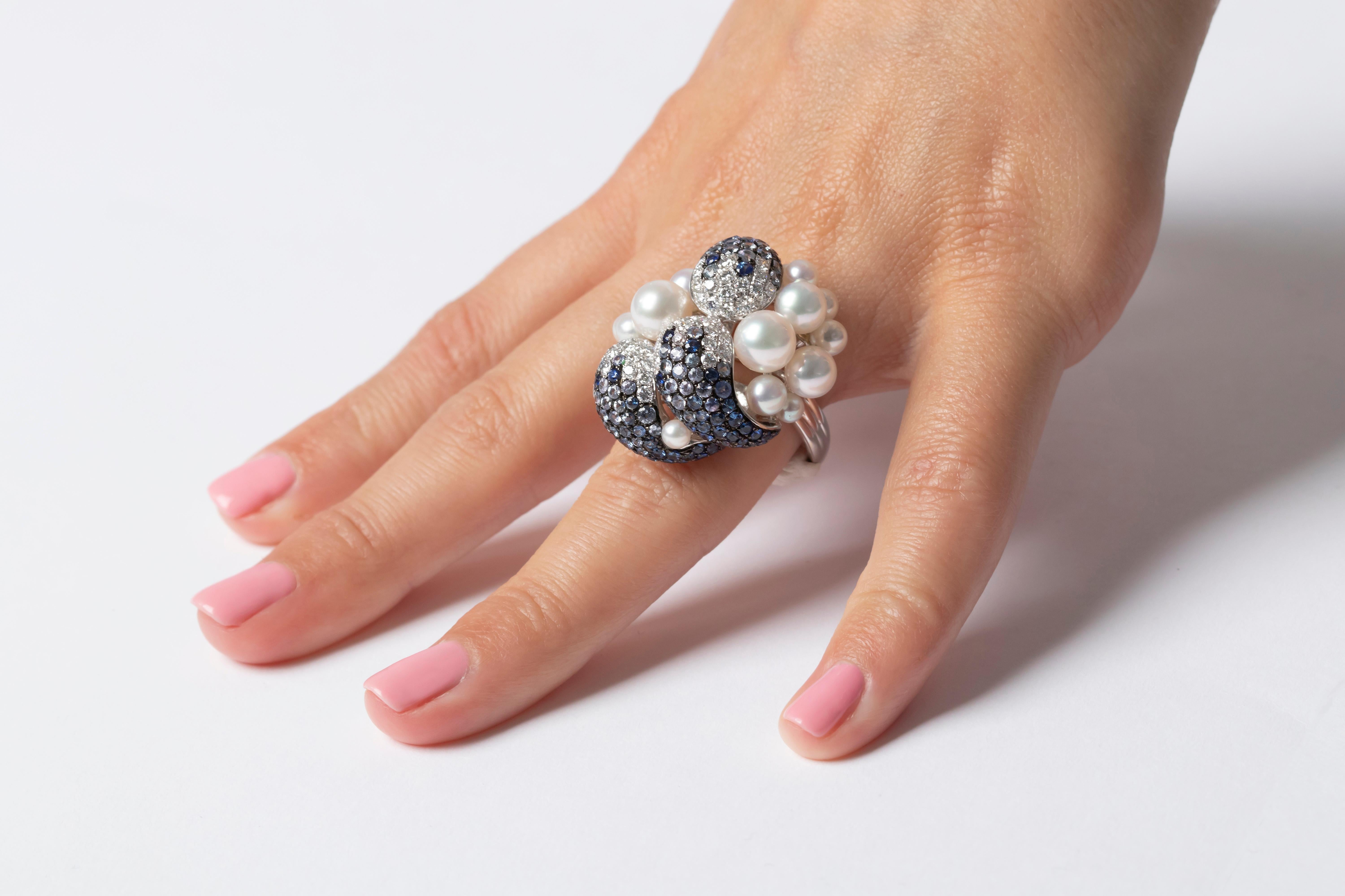 A stunning cocktail ring by Yoko London featuring an eclectic array of blue sapphires, diamonds and Japanese Akoya pearls. This statement ring is a one-of-a-kind design, which is sure to set you apart from the crowd. Complete the look with the
