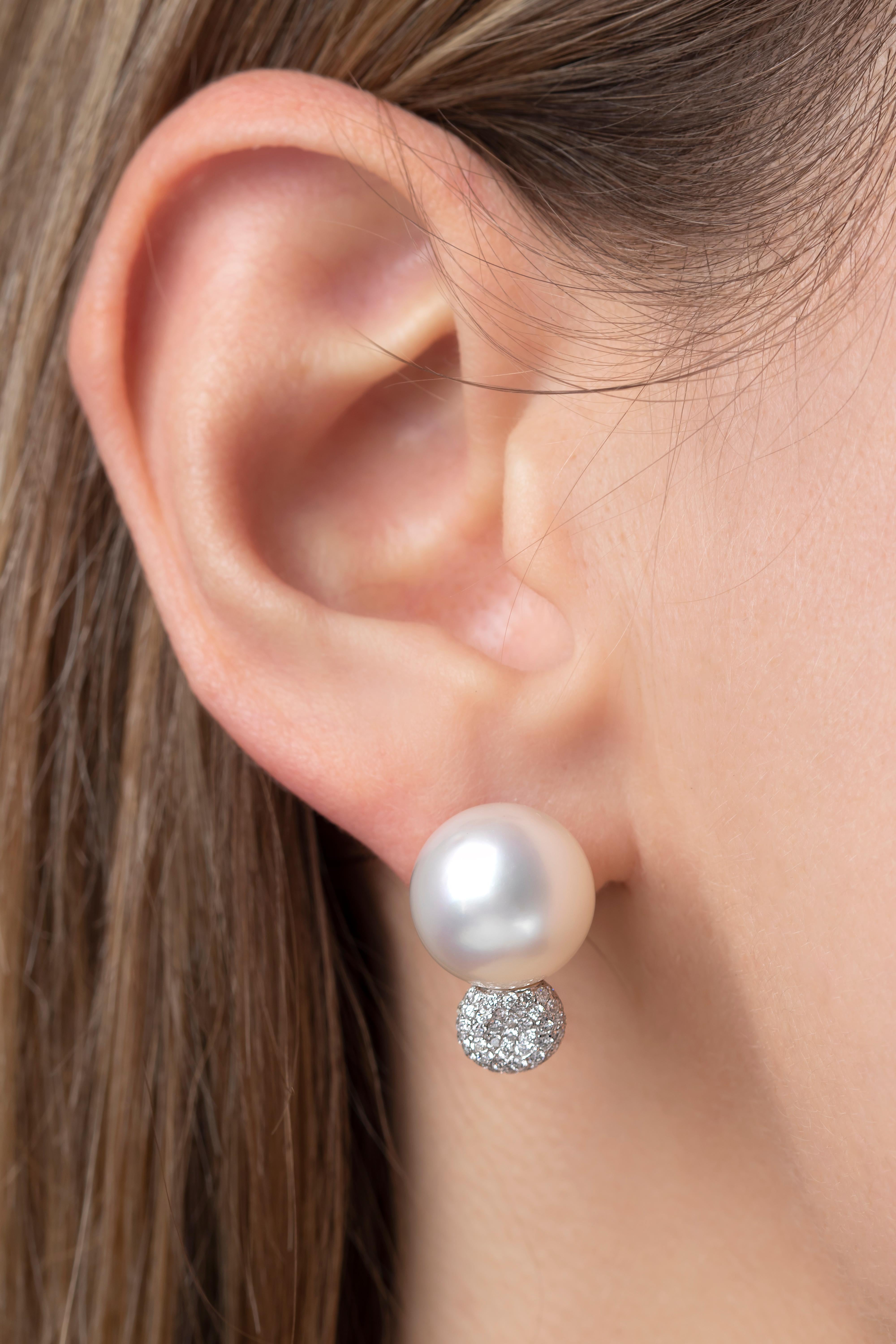These elegant earrings by Yoko London feature lustrous South Sea Pearls atop a cluster of dazzling diamonds. Set in 18 Karat White Gold to enrich the radiance of both the pearls and the diamonds, these earrings utilise a classically beautiful