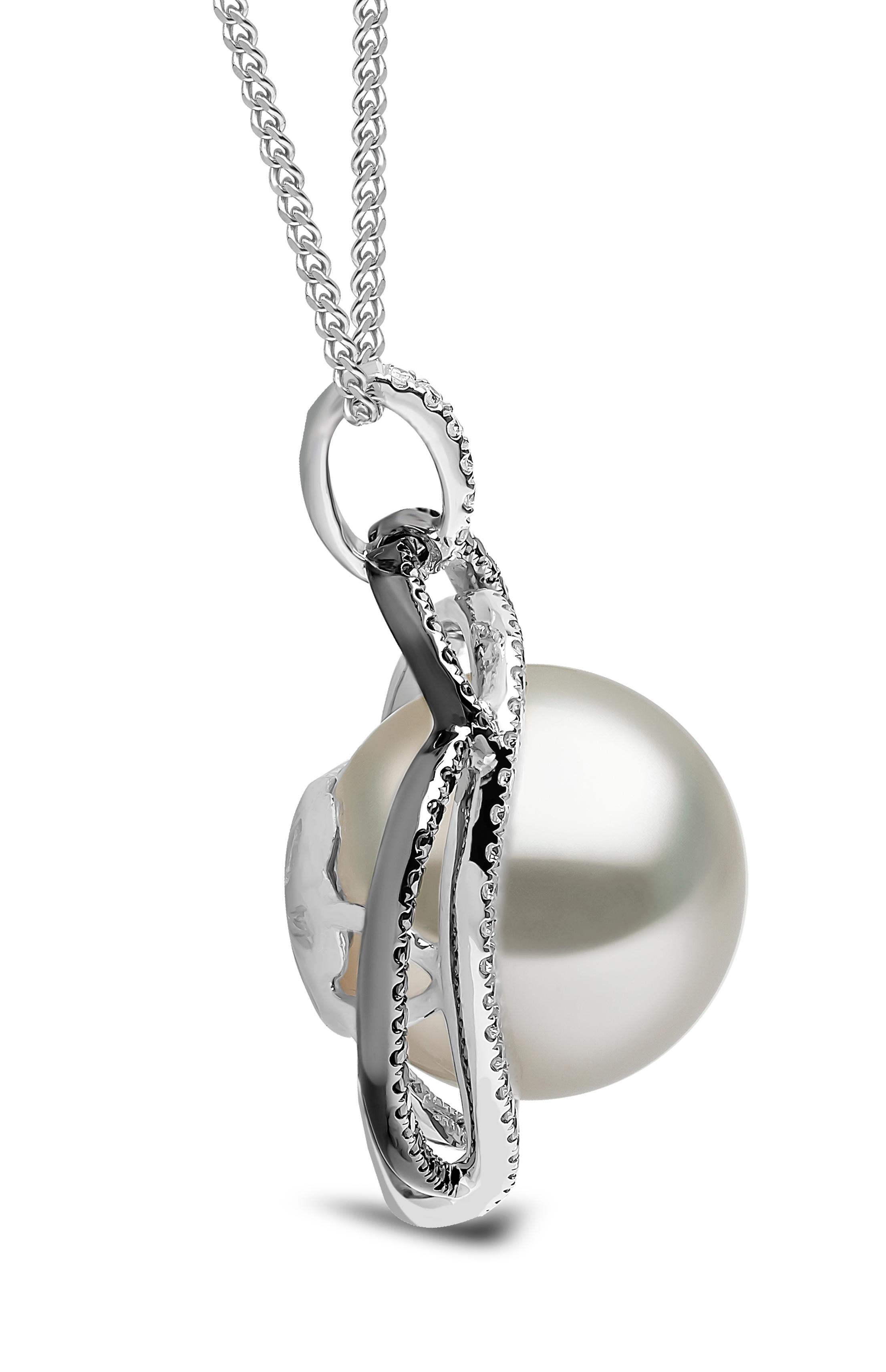 This unique pendant by Yoko London features a lustrous South Sea pearl set amongst a combination of black and white diamonds. The diamonds intertwine to create two abstract hearts. A romantic, but striking piece, this beautiful pendant will add an