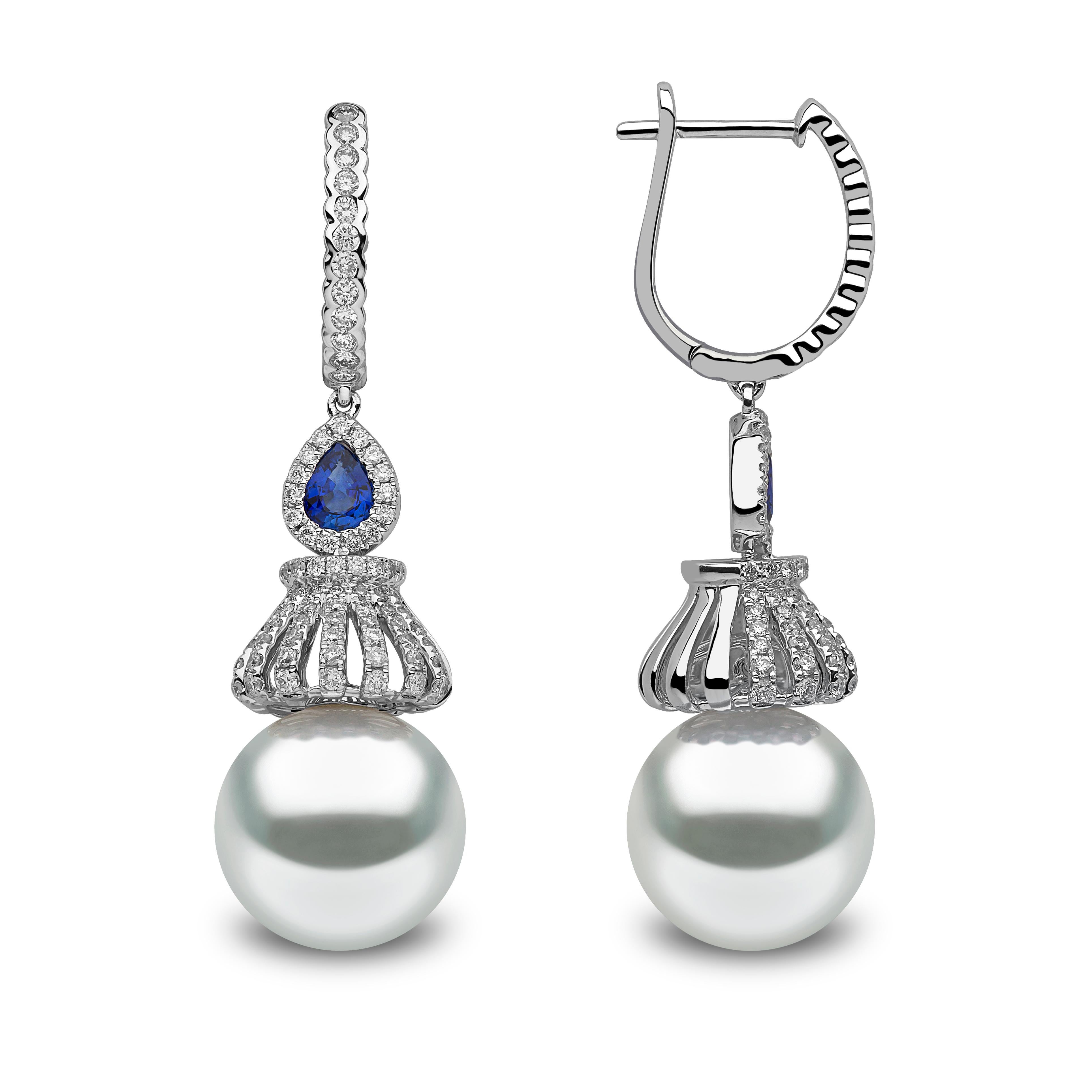 These elegant 18ct white gold earrings feature high quality South Sea pearls, beneath a mesmeric combination of diamonds and  pear cut sapphires. These unique earrings will add a pop of color to any outfit. 

- 12-12.5mm South Sea Pearls
- 0.88ct of