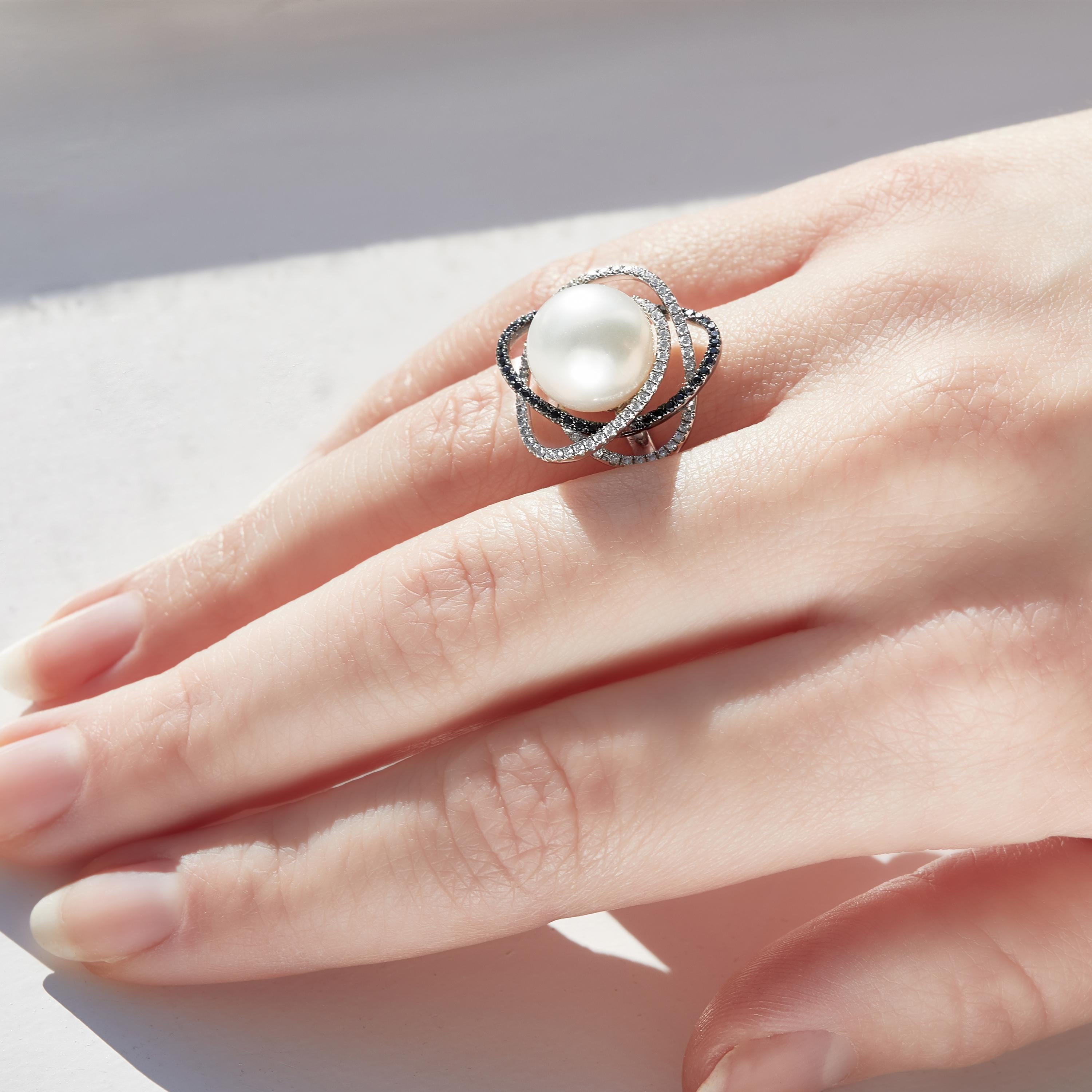 This exceptional ring by Yoko London features a lustrous South Sea pearl surrounded by delicate orbits of black and white diamonds. Expertly crafted in 18 Karat white gold in our London atelier, this striking ring adds a unique twist to the most
