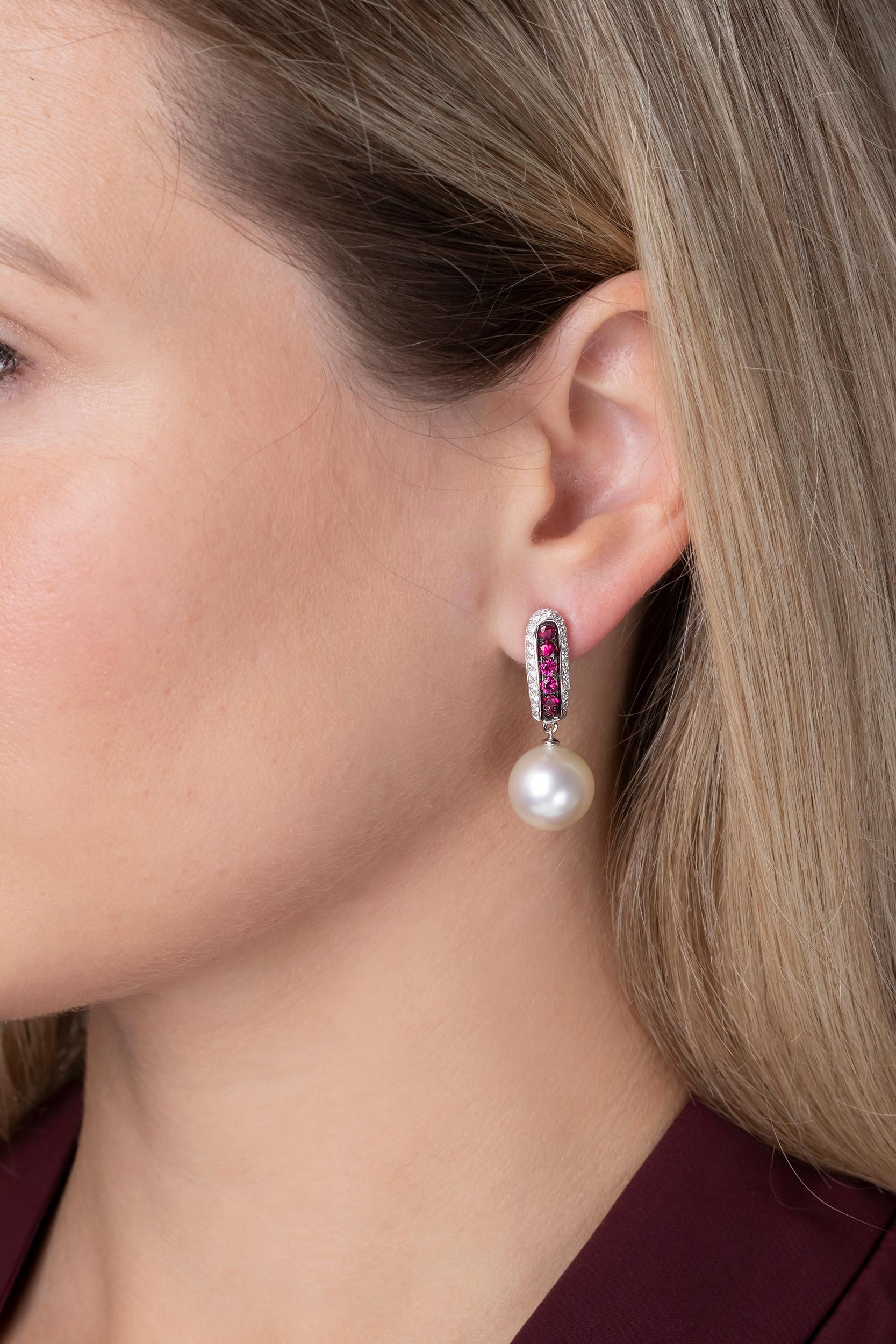 These elegant earrings by Yoko London feature lustrous South Sea pearls beneath a striking combination of rubies and diamonds. Designed to offer a unique allure, these spectacular earrings have been hand-finished in London to the highest standard.