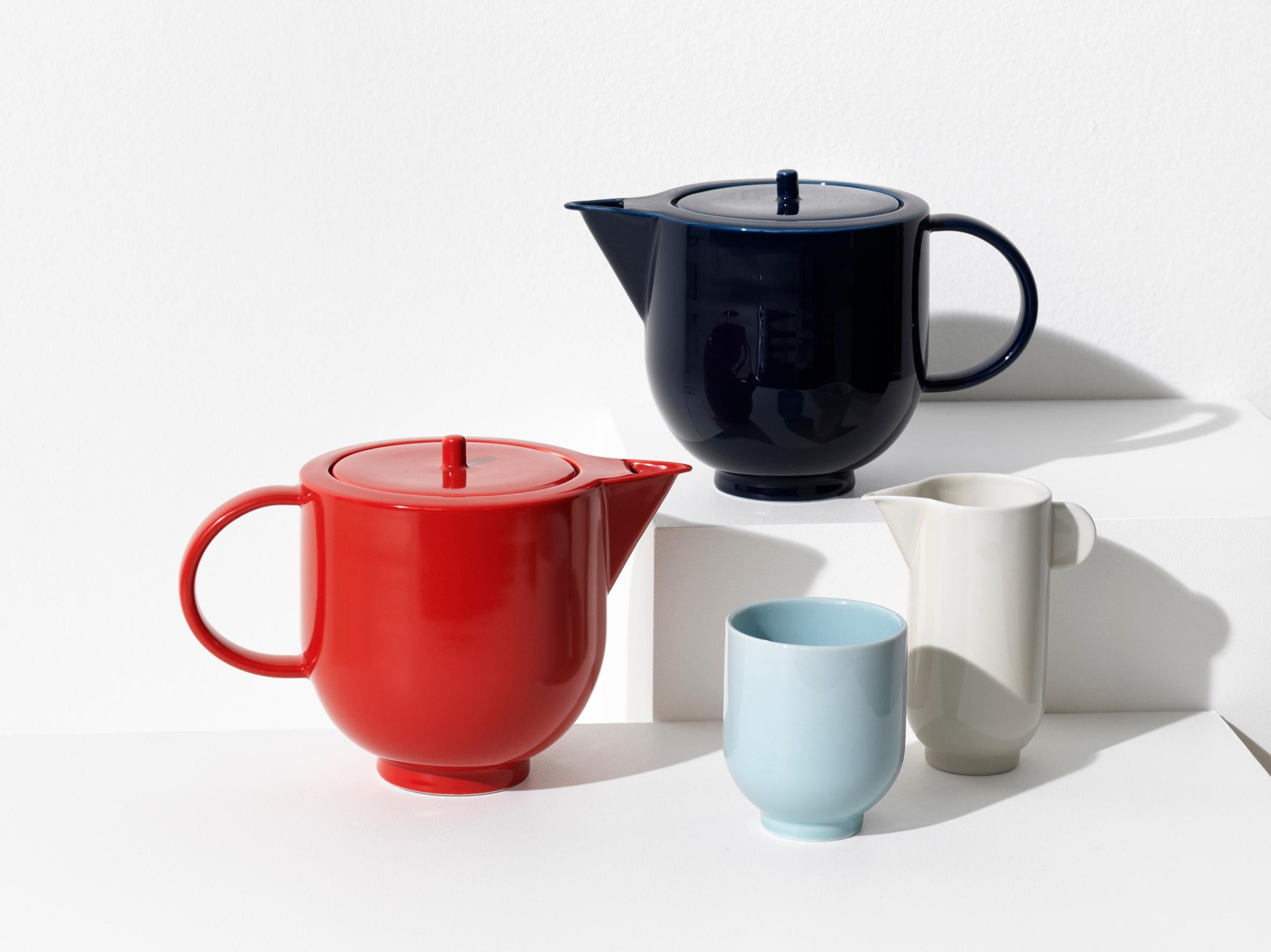 The YOKO pitcher is a significant and distinctive piece of tableware. Its simple, sculptural shape with strong, sharp edges challenges the soft material of porcelain.

The pitcher is available in eggshell white and dark navy blue. It contains