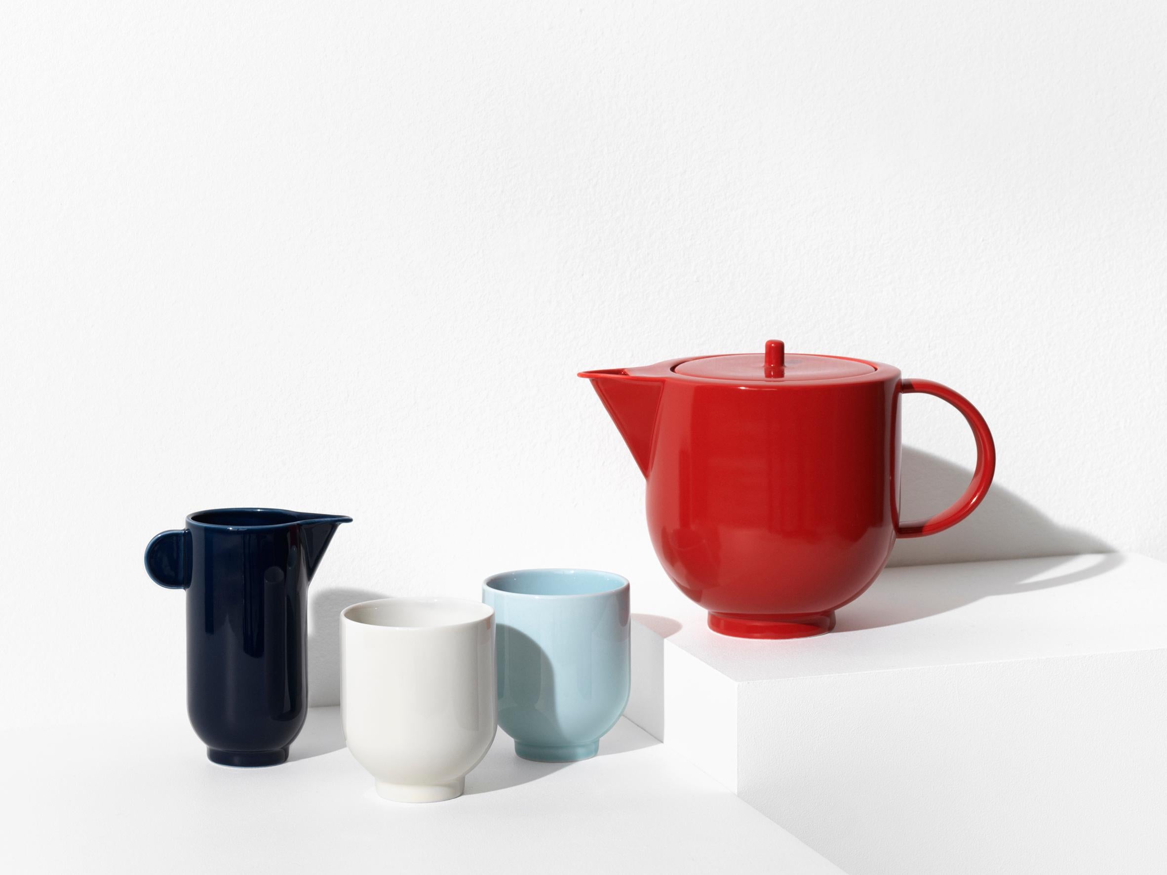 The YOKO pitcher is a significant and distinctive piece of tableware. Its simple, sculptural shape with strong, sharp edges challenges the soft material of porcelain.

The pitcher is available in eggshell white and dark navy blue. It contains