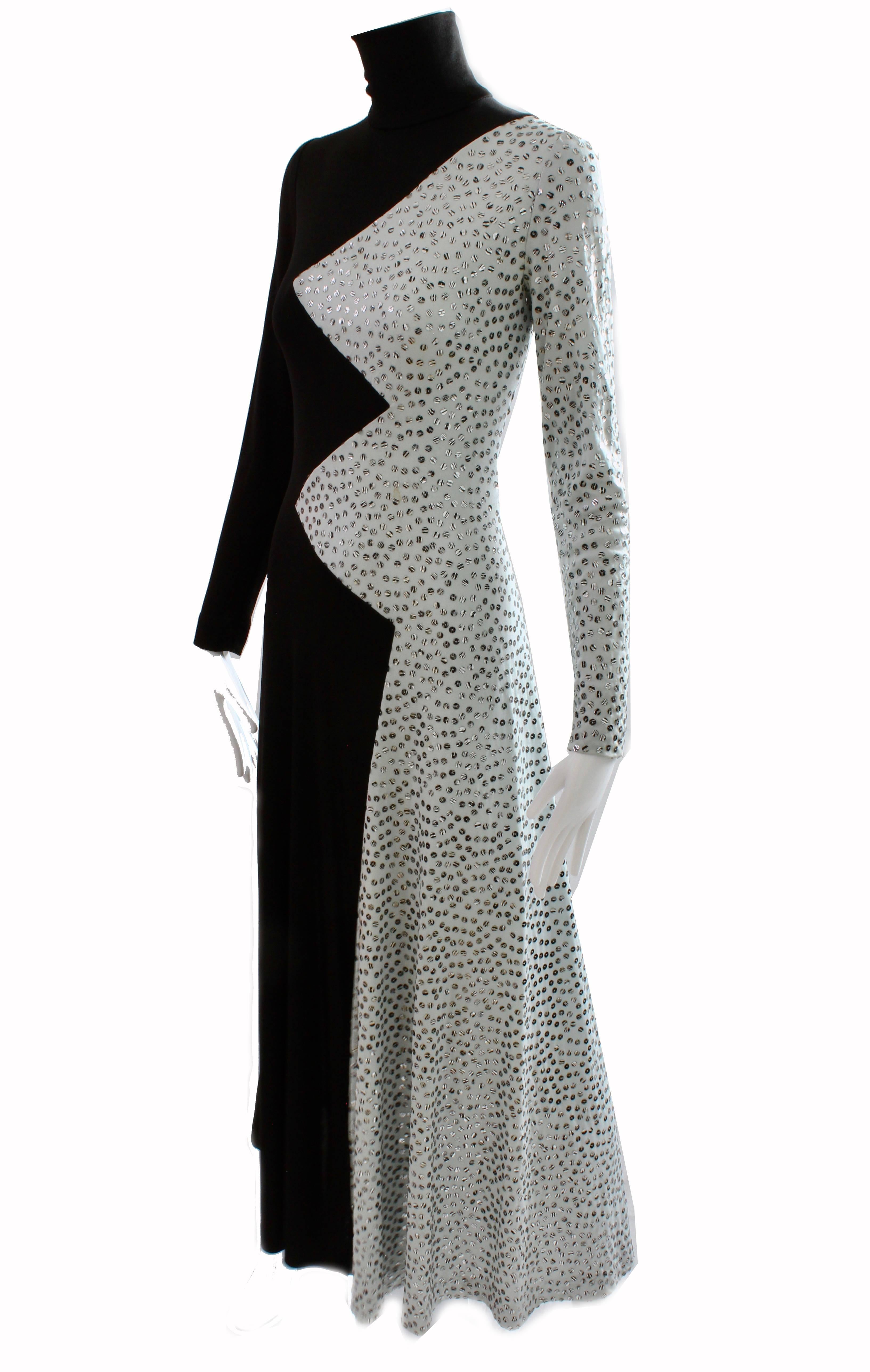 This incredible long dress was made by Boston designer Yolanda Cellucci for her Yolanda's Originals label, most likely in the late 60s or early 70s.  Made from a black and dove gray jersey fabric, it features a zig zag pattern down the front center,