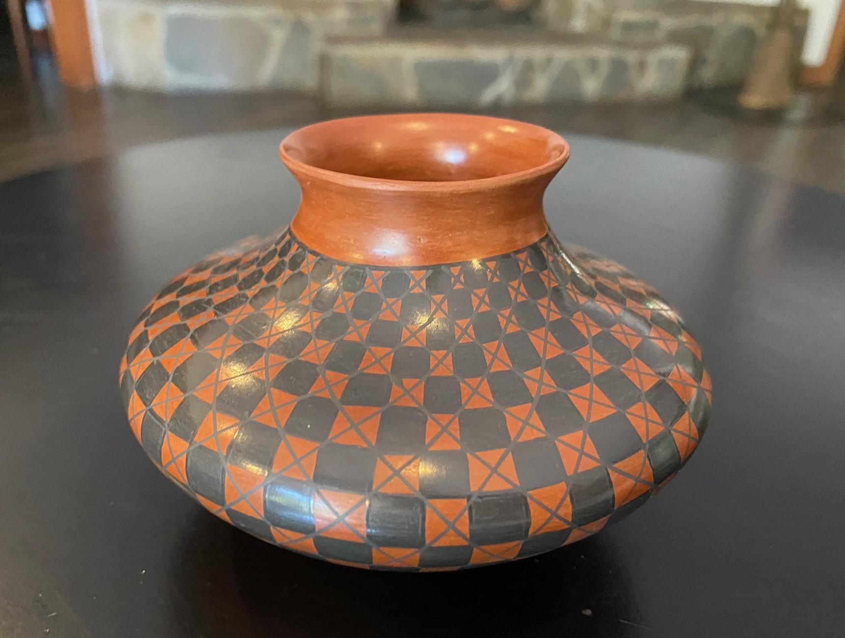 A beautiful designed, shaped and decorated ceramic vase by Ingenious Southwest Native American potter Yolanda (Yoly/Yolly) Ledezma  of Casas Grandes Pottery in Mata Ortiz, Chihuahua, Mexico.  This work features gorgeous, rich coloring with a