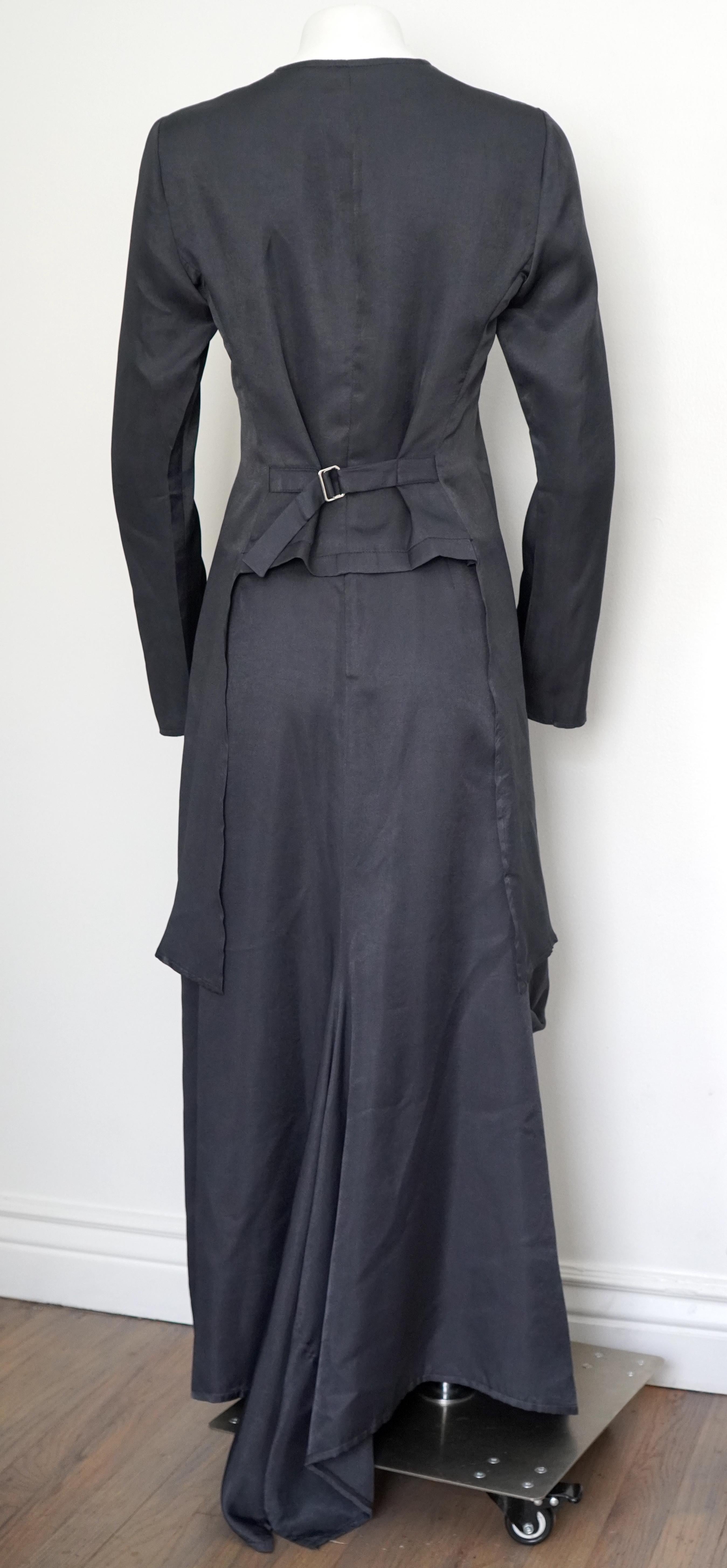 This two-piece set by Yoneda Kasuko Paris has a cropped button top with the sides of it cascading down the sides and the back of the top has an adjustment for fit. 
The top is a size 42, 38