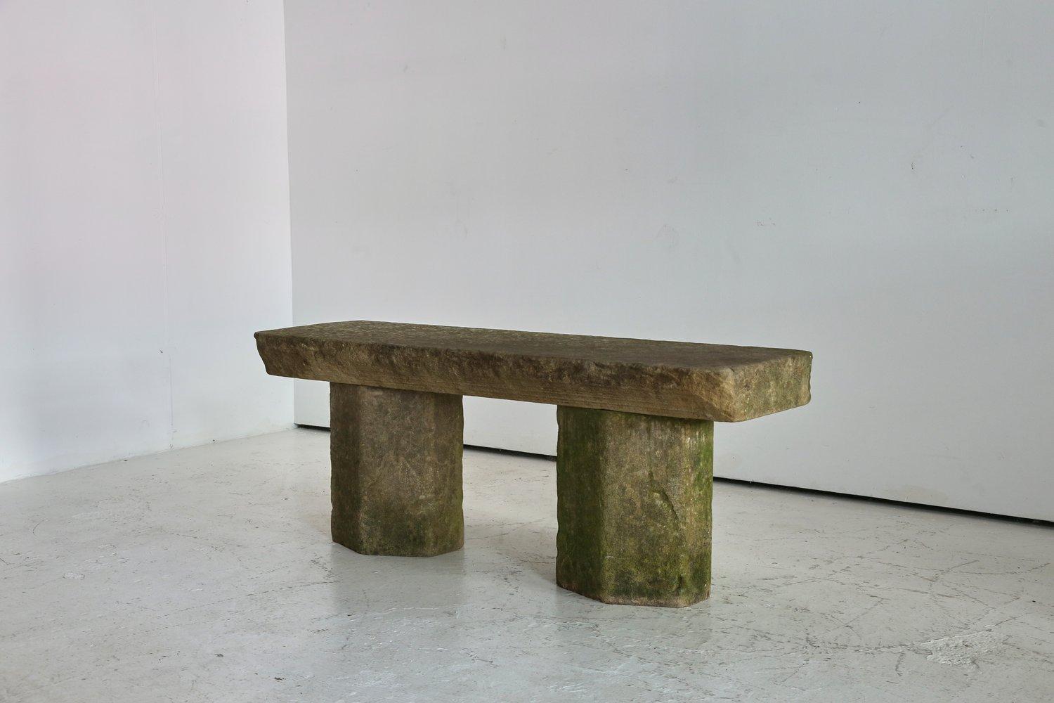 Monumental antique pedestal bench. 

Constructed from reclaimed York stone architectural elements. 

The seat being shaped from one thick block, with a tapered front edge.

Has all the wonderful weathering left in, lichen and moss present