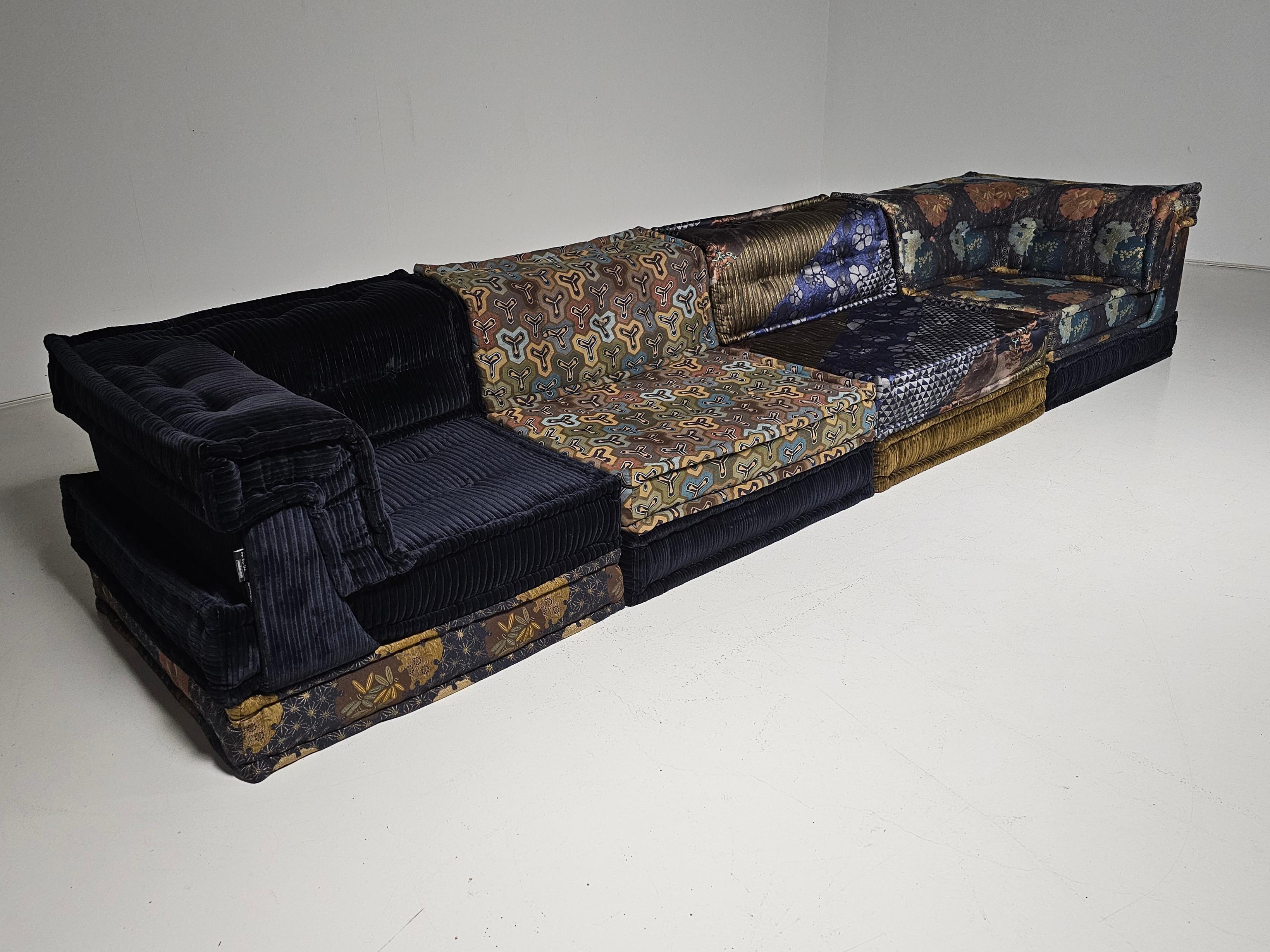 Yoru Mah Jong modular sofa set by Hans Hopfer, designed in 1971 for Roche Bobois and in a customized mix of textiles by Kenzo Takada. it features multiple cushions that can be arranged in an endless number of ways, This set includes 8 cushions, 2