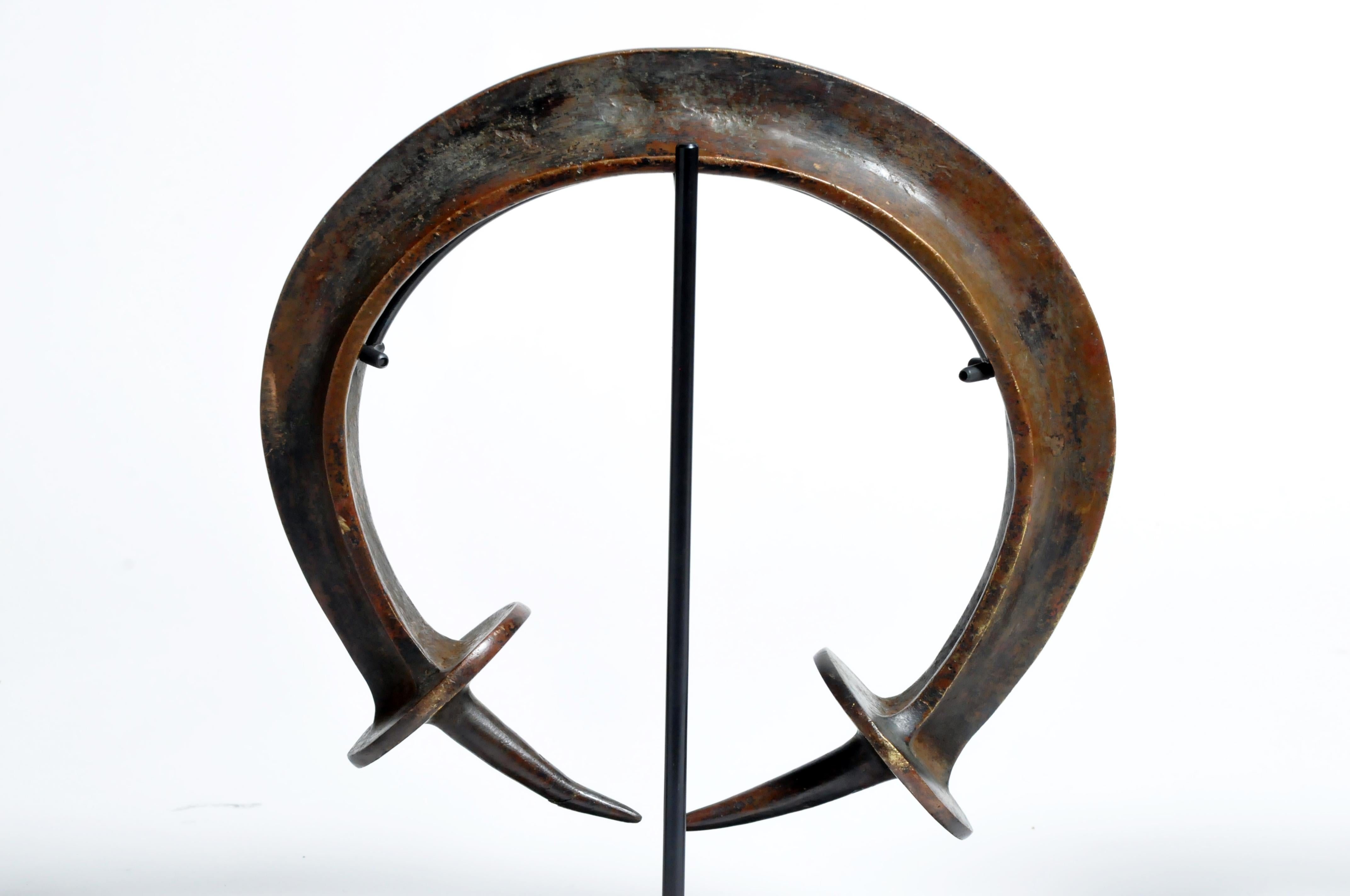This Yoruba style neck ring was cast from copper alloy using the lost wax method. The Yoruba are found principally in Nigeria and Benin. The piece dates to the mid-20th century. Metal mounting is included.