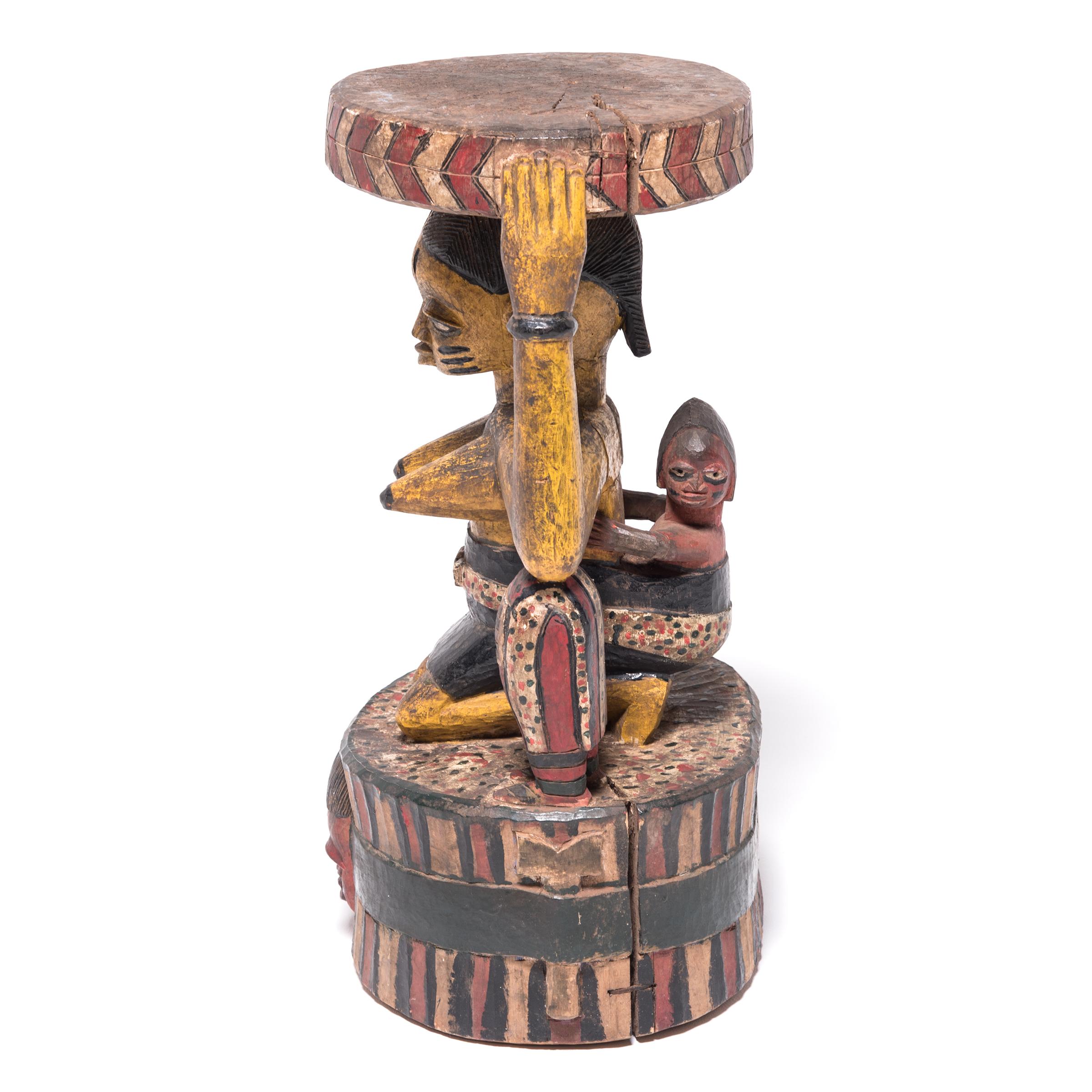 Carved in a classic Yoruba form, this figurative stool is unusual for its highly patterned painted surface. Using traditional techniques, a single tree trunk was carved into a column, then taken in further until the form of a kneeling woman