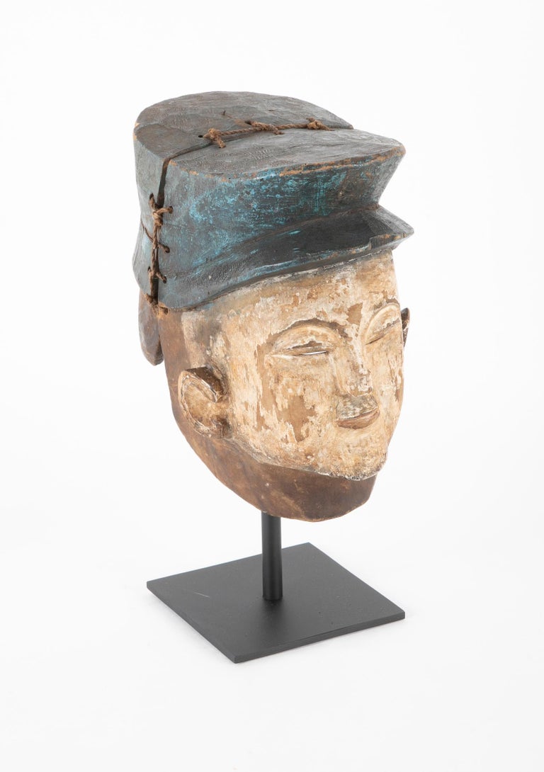 A Yoruba Tribal 'Gelede' Helmet Mask of a French Gendarme A Yoruba Tribal 'Gelede' Helmet Mask of a French Gendarme