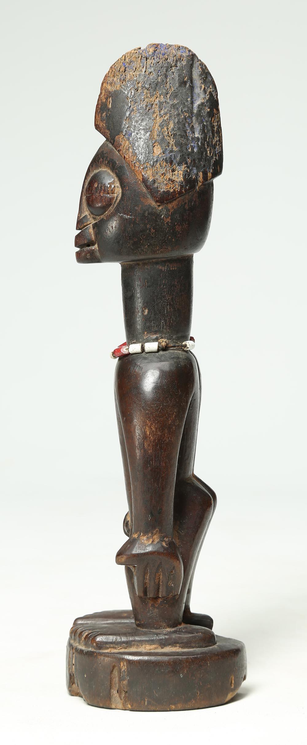 Yoruba tribal male figure, an Ibeji or twin figure, Nigeria, Africa, large eyes

A finely carved Yoruba Male Ibeji figure with pointed headdress, large expressive eyes on a circular base with heavy wear and polish from native use, Glass bead