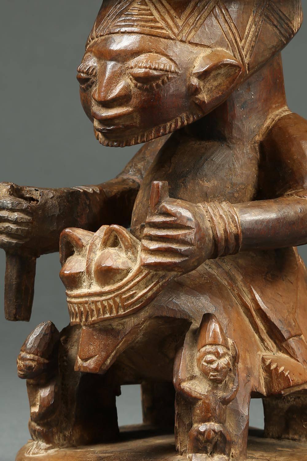 Yoruba tribal offering bowl with horse and rider, Nigeria, 10 1/2 inches tall.

Offering bowl from the Yoruba with a male figure riding a horse, holding onto the reins in one hand, probably once held a sword in the other, top of the sword missing.