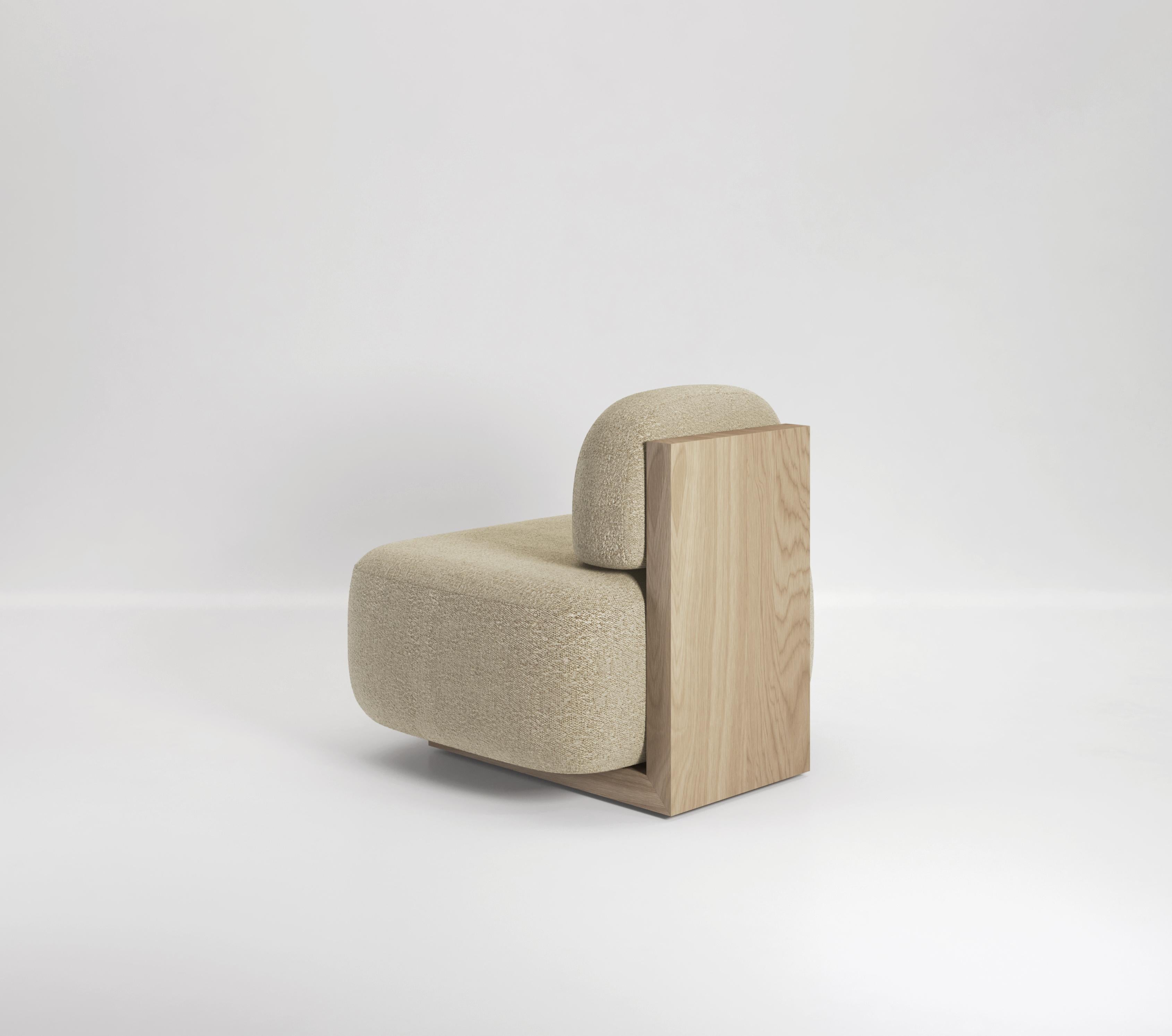 The Yoshida lounge chair is a minimal piece designed to look great from all angles. From the front, two oversized cushions seem to float, unsupported and balancing in place. From behind you see a large solid wood piece which acts as both the base