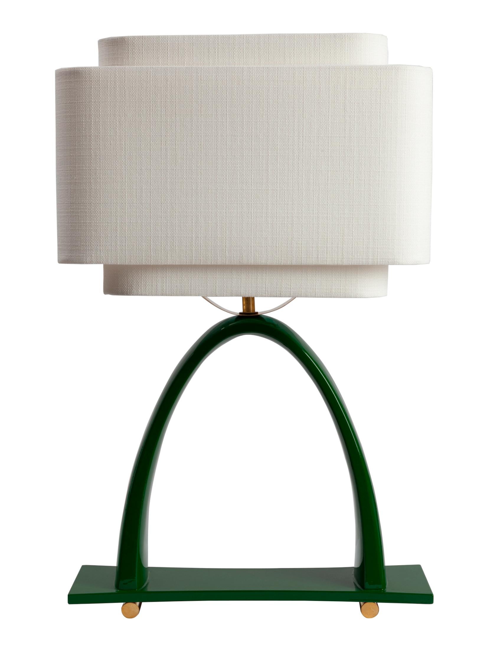 Yoshiko Table Lamp by Kira Design
Dimensions: ⌀ 37 x H 58 cm
Materials: Ceramic, Linen, Brass, Lacquered Wood
Available Colors: Blue, Red, Green, Black.

The Yoshiko desk lamp reveals delicate, slender curves, counterbalanced by a double shade that