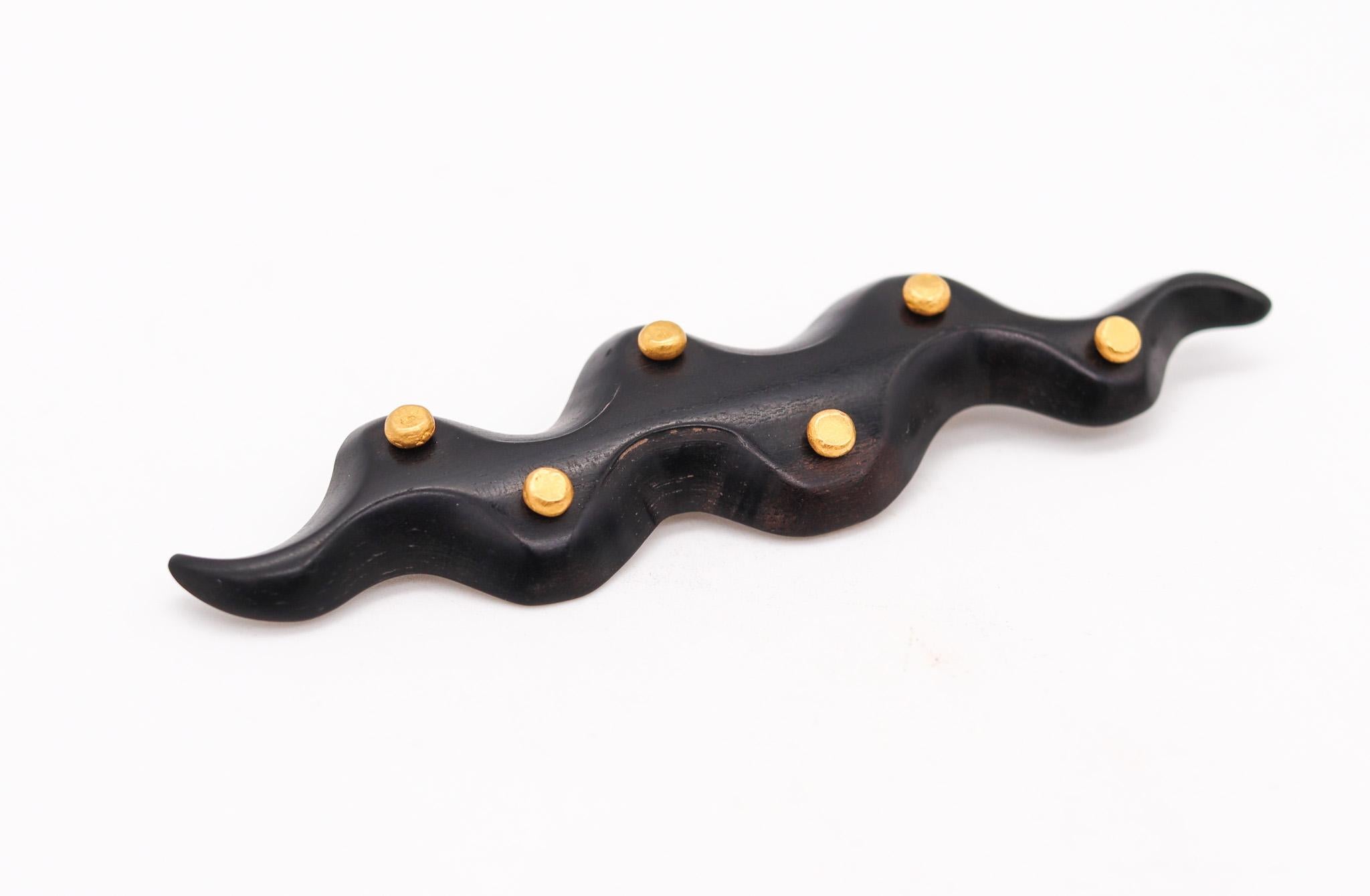 Naive wood brooch by Yossi Harari.

Beautiful contemporary brooch, created by the goldsmith and designer Yossi Harari. It was carefully made with ancient jewelry techniques in carved black ebony wood and parts crafted in solid gold of 24 karats with