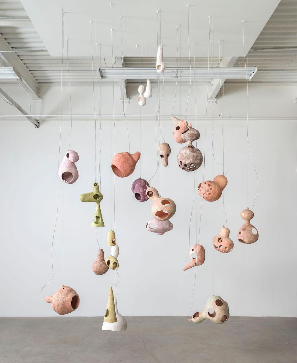 Floating objects surround you. You wonder if you too are floating in space, or perhaps in water. Gravity, the horizon, and the edges of the room disappear. You are happy.

You See a Sheep is a chandelier that uses hand-built ceramic shells to