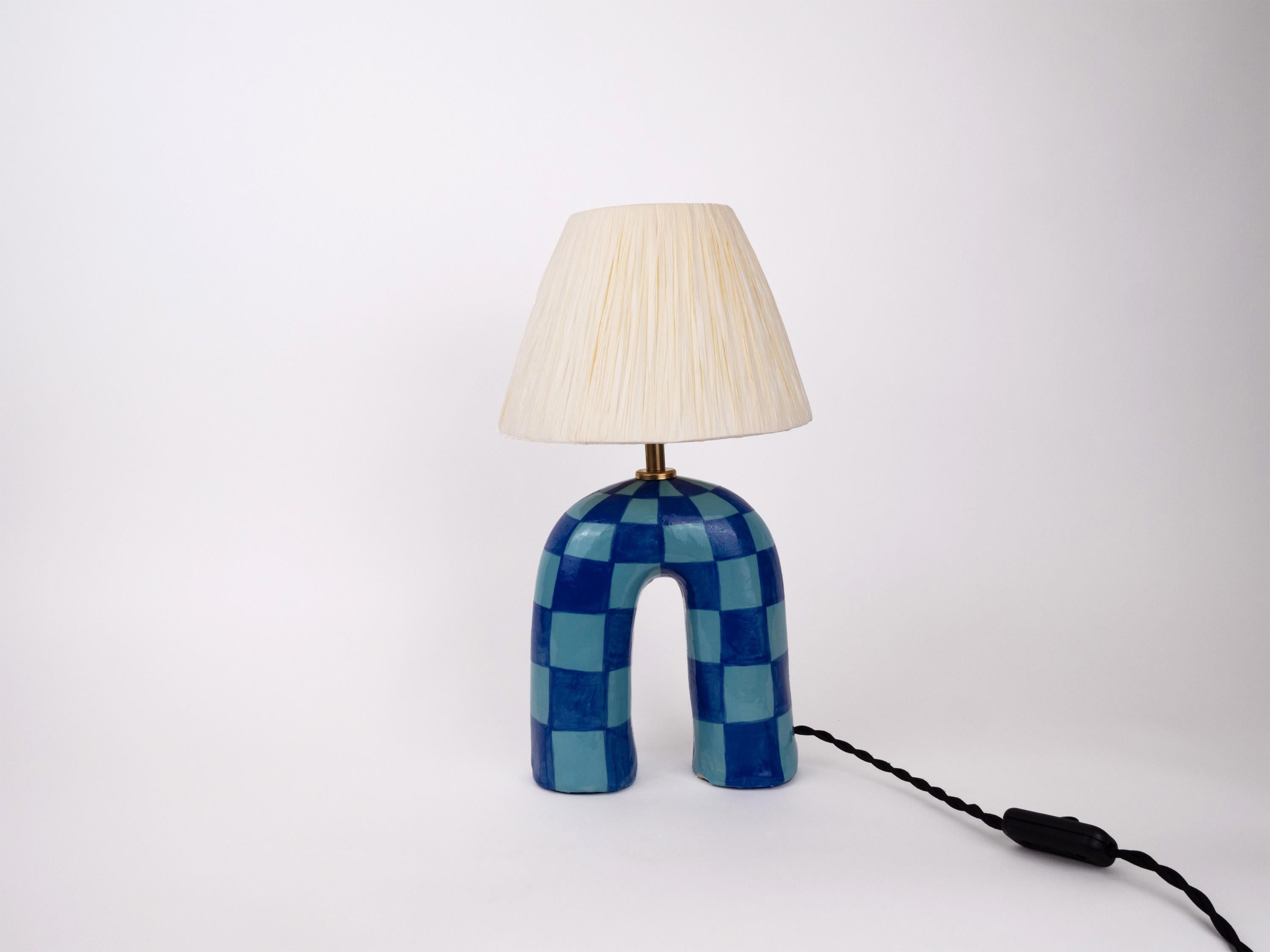 Two-tone Blue lamp base with a checkerboard pattern and glossy finish paired with an Ivory raffia shade

Bulb NOT included
Recommended bulb fitting: E27/26 
Recommended bulb type: Mini Globe LED

The estimated processing time is 2 weeks from order