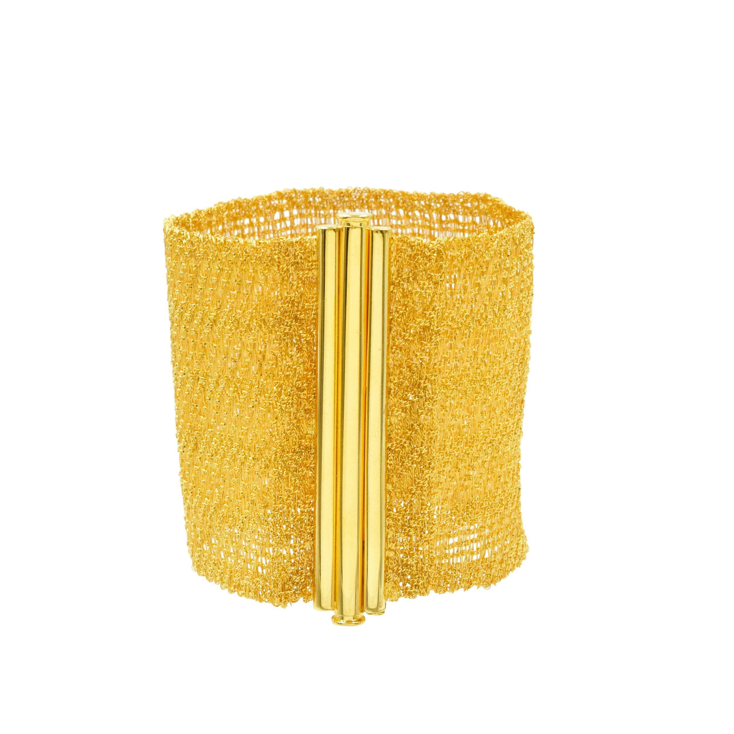 Youmna 18k yellow gold mesh statement bracelet. This wide bracelet consist of 18k yellow gold mesh with
bar clasp. Wrist size is 7 inches. Mesh width: 60mm, lock width: 65mm. Inscribed: Youmna, 750. 
Weight:  56 grams