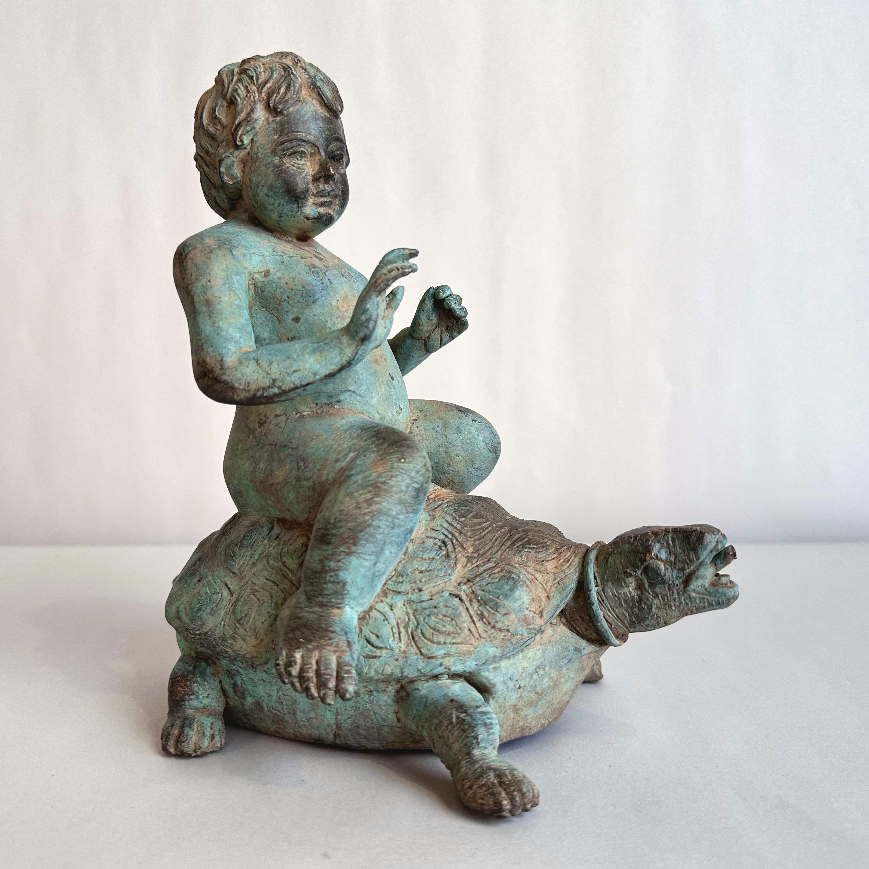 A delightful circa 1920 antique patinated cast bronze fountain head sculpture depicting a cherubic young boy riding a turtle, and more specifically, a Galápagos tortoise.

With a benevolent—yet somewhat inscrutable—expression on his face, our nicely