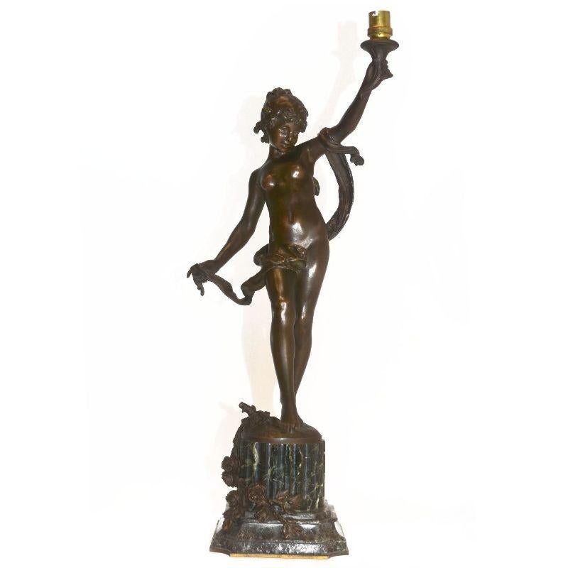 Young girl carrying torch on green marble base with medal patina, late 19th century. Sign Auguste Moreau on the late 19th century terrace mounted as an electric candle holder electricity to be redone dimension 59 cm total height terrace dimension 15
