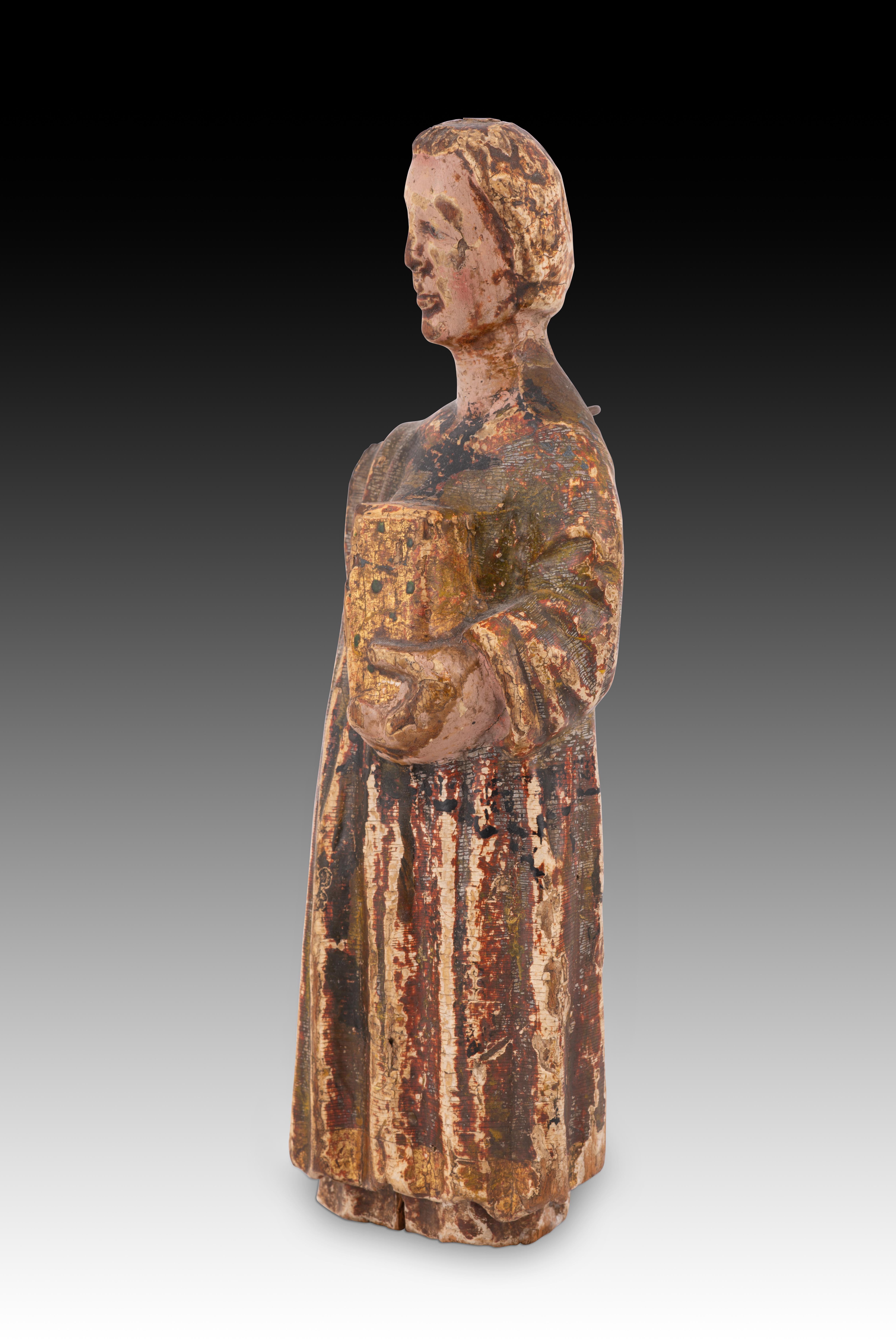 Young man in a tunic. Carved and polychrome wood. Spanish school, 14th century. 
Figurative carving made of wood that still preserves traces of polychromy and gilding. It would probably be a young man (without a beard and uncovered hair), with an