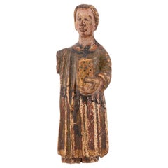 Young man in a tunic. Carved and polychrome wood. Spanish school, 14th century.