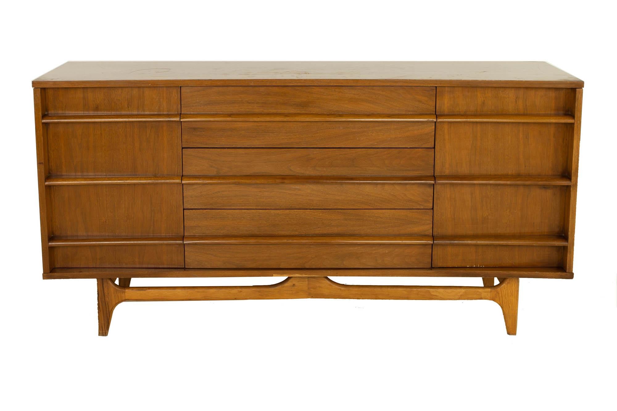 Young Manufacturing Mid Century Curved Front Walnut Sideboard Credenza

This credenza measures: 64 wide x 18 deep x 34 inches high

?All pieces of furniture can be had in what we call restored vintage condition. That means the piece is restored upon