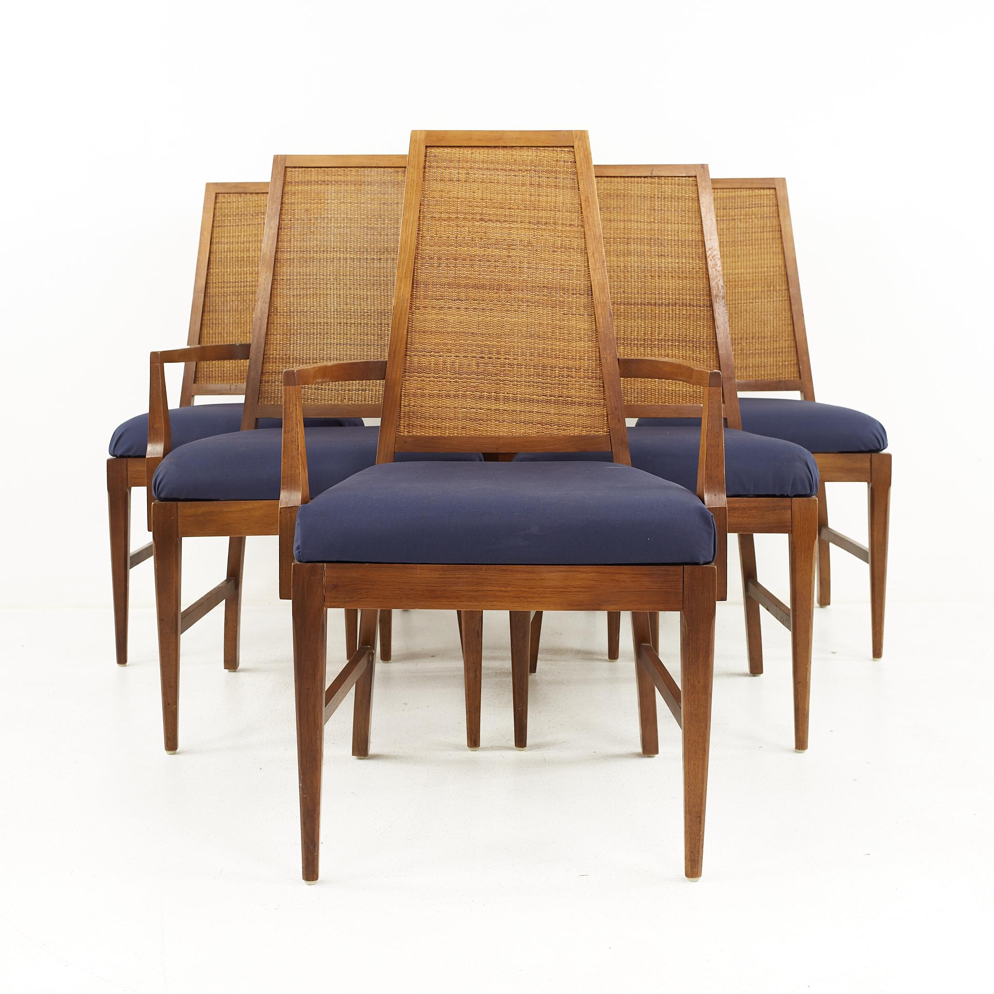 Young Manufacturing mid century walnut cane back dining chairs - Set of 6

The captains' chairs measure: 22.75 wide x 22 deep x 39.5 high, with a seat height of 19 inches and arm height of 25.5 inches 
The side chairs measure: 19.5 wide x 20 deep