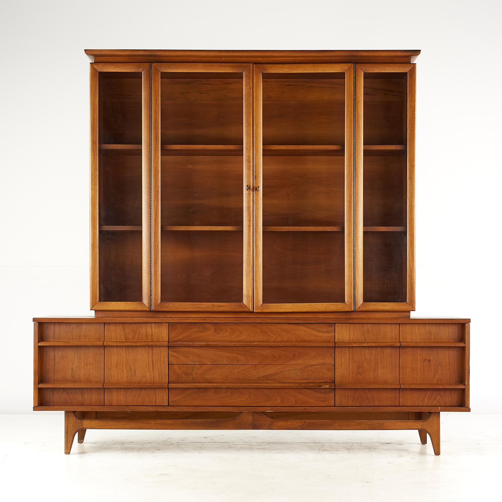 Young Manufacturing mid-century walnut curved buffet and hutch.

The buffet measures: 64 wide x 19 deep x 24.75 inches high
The hutch measures: 60 wide x 12.5 deep x 49 inches high
The combined height of the buffet and hutch is 73.75