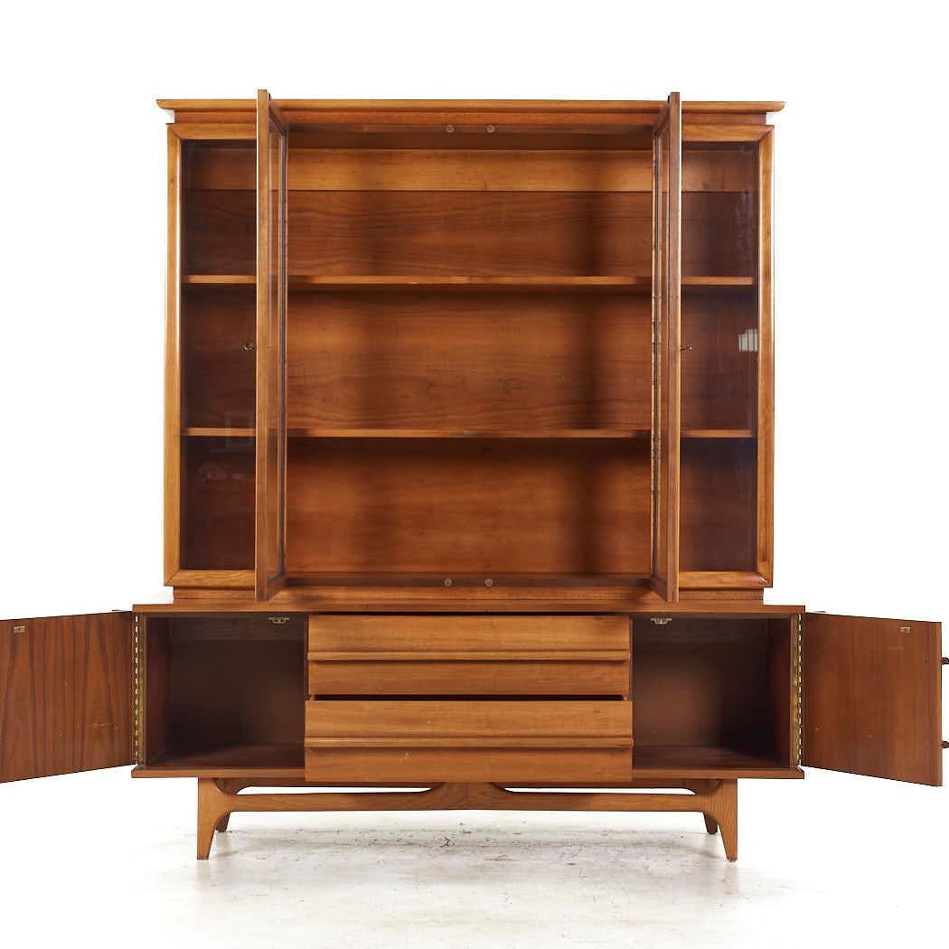 Young Manufacturing Mid Century Walnut Curved Buffet and Hutch

The buffet measures: 64 wide x 19 deep x 24.75 inches high
The hutch measures: 60 wide x 12.5 deep x 49 inches high
The combined height of the buffet and hutch is 73.75 inches

All