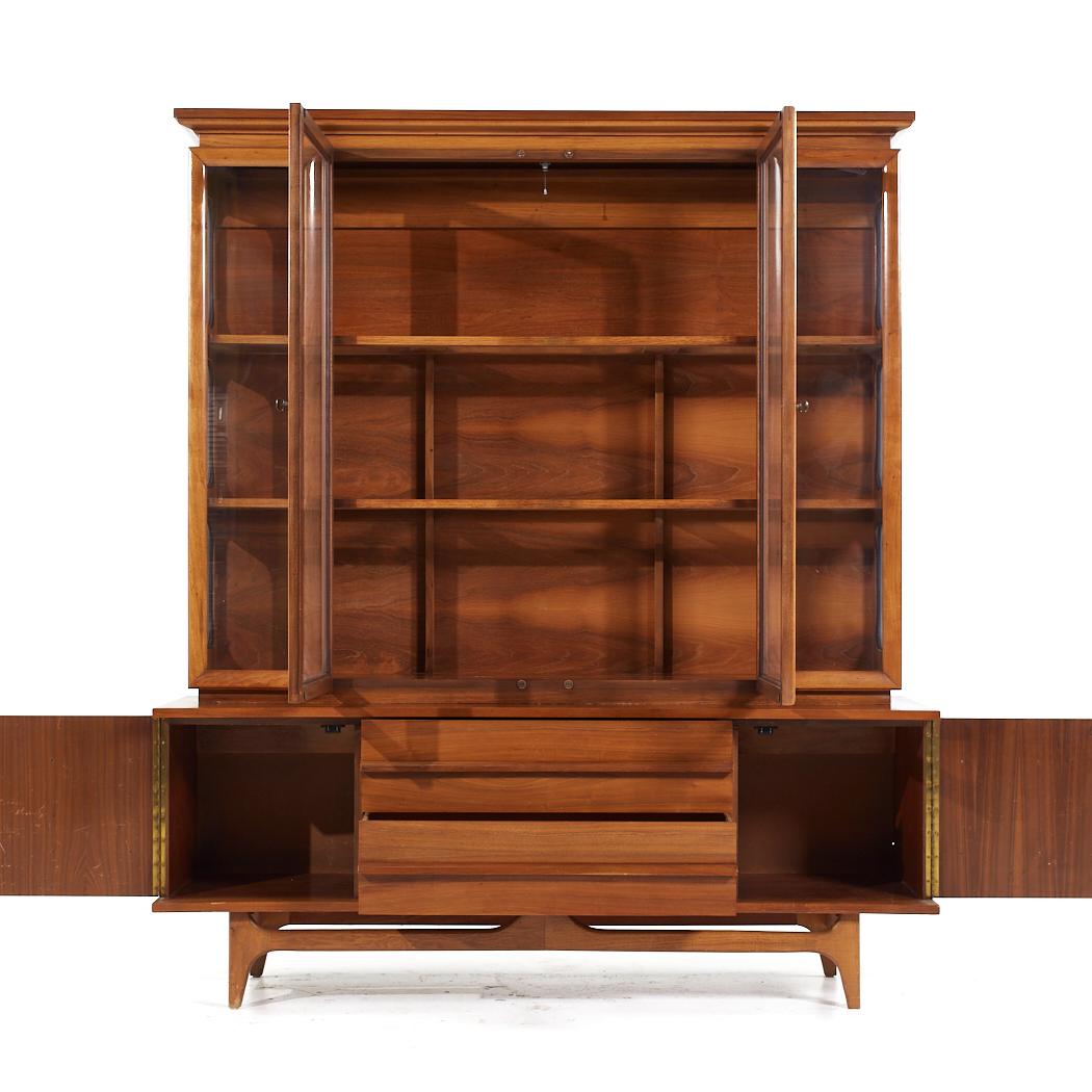Young Manufacturing Mid Century Walnut Curved Buffet and Hutch

The buffet measures: 64 wide x 19 deep x 24.75 inches high
The hutch measures: 60 wide x 12.5 deep x 49.75 inches high
The combined height of the buffet and hutch is 74.5 inches

All
