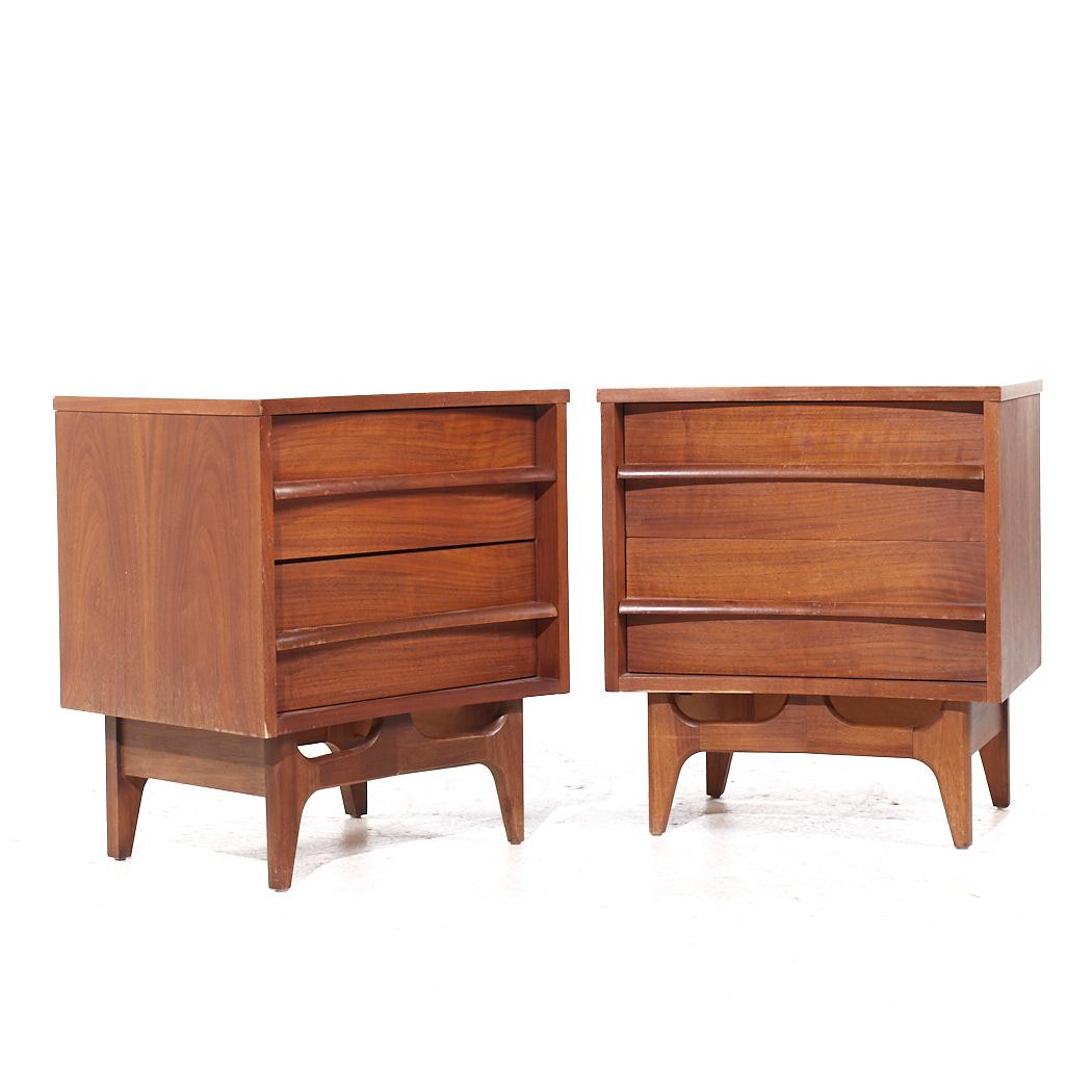 Young Manufacturing Mid Century Walnut Curved Nightstands - Pair

This nightstand measures: 22 wide x 17 deep x 24.75 inches high 

All pieces of furniture can be had in what we call restored vintage condition. That means the piece is restored upon